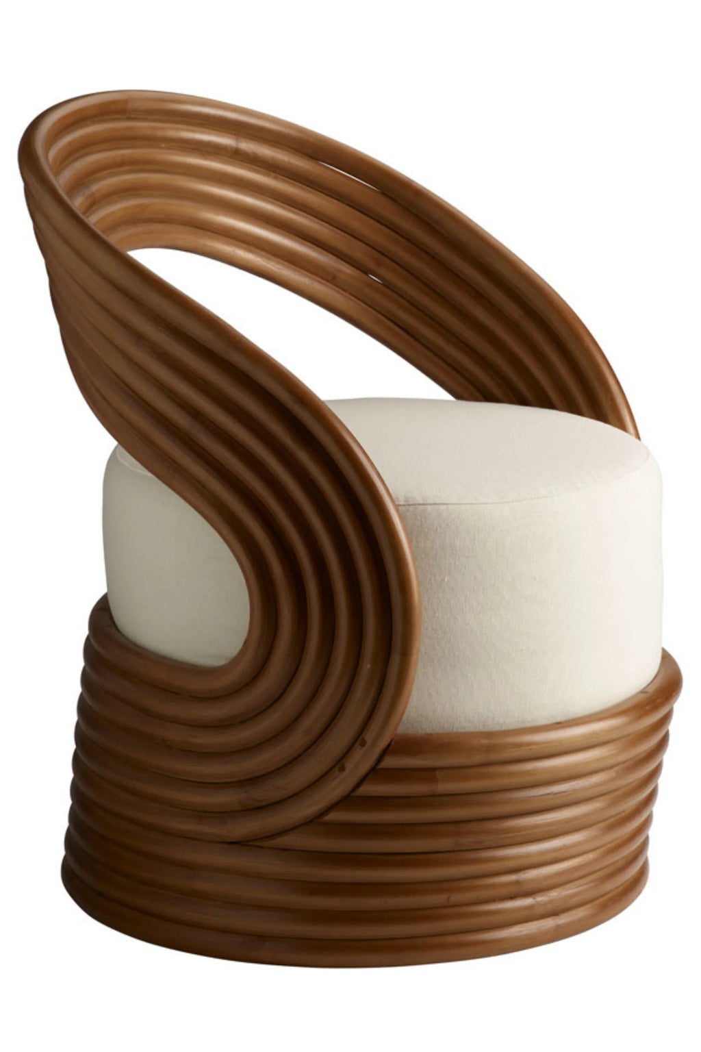Tine K Mano Armchair, a sculptural organic modern lounge chair featuring a distinctive curved frame crafted from warm brown bent rattan, forming a barrel-like base and an open, flowing backrest. It boasts a plush, round cream-colored upholstered seat cushion, providing comfort and a soft contrast to the natural rattan. This contemporary rattan armchair is ideal for coastal living rooms, bohemian bedrooms, or as a chic accent chair in a reading nook.