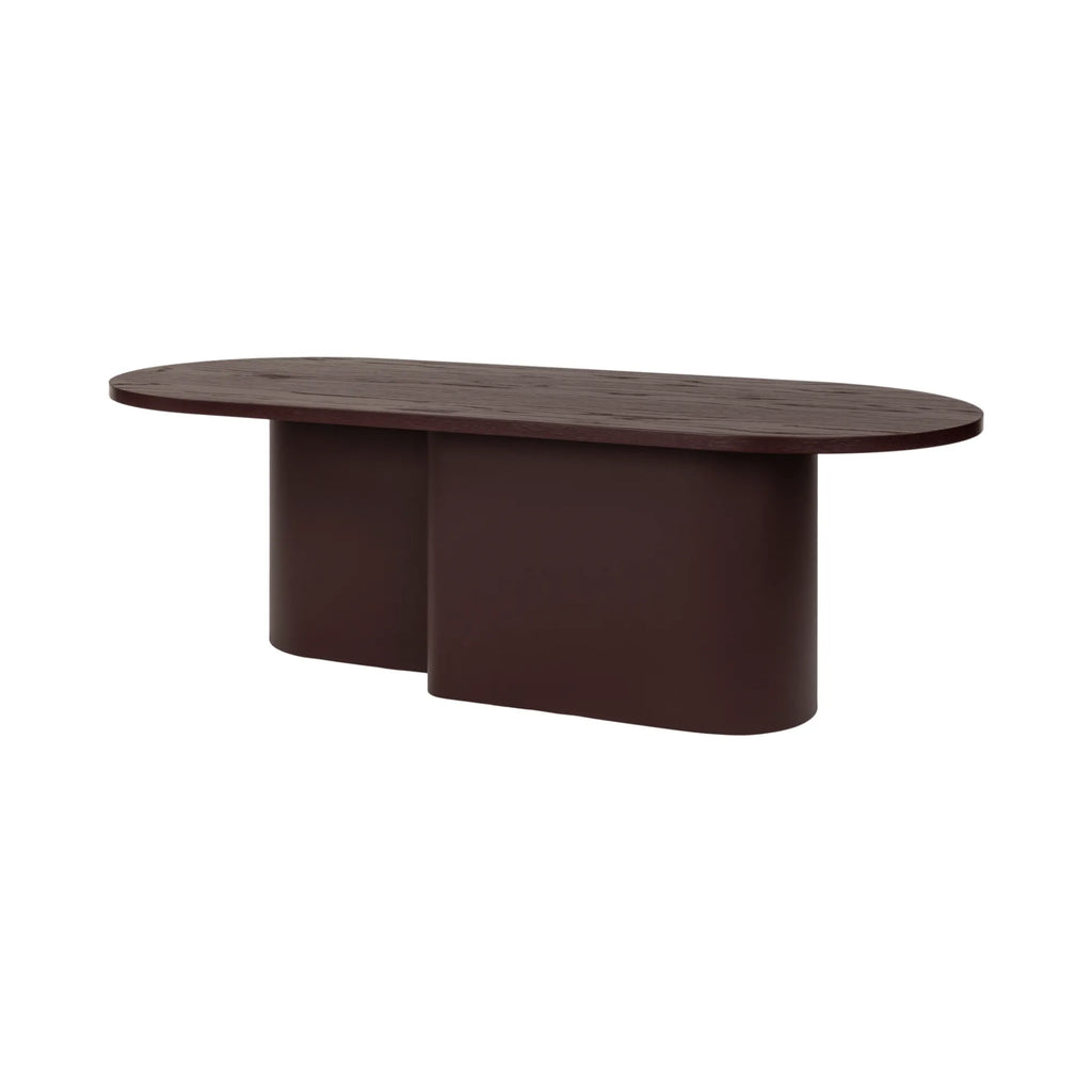 noo.ma Looi Coffee Table, a modern minimalist dark brown wood coffee table featuring an elongated oval tabletop with a distinct wood grain texture, supported by two softly curved, joined pedestal bases.