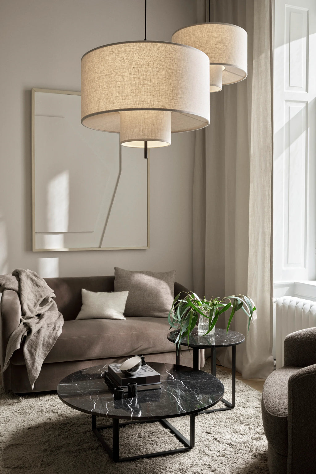 New Works Florence Side Table, a sleek modern minimalist side table featuring a round polished black marble tabletop with striking white veining and a sturdy matte black metal frame. This contemporary accent table is perfect for living room styling, as a chic bedside table, or for adding a touch of sophisticated design to any space.