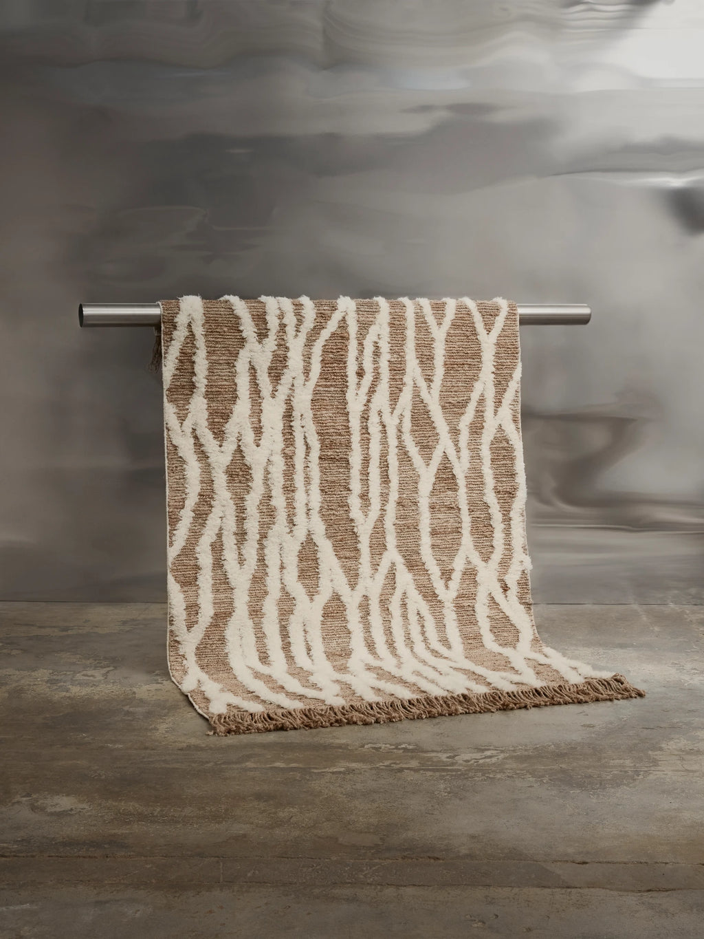 Tinted Objects Wahl Jute Rug, featuring a modern abstract pattern of soft white plush loops against a natural brown woven jute base, with delicate fringed edges. This stylish, durable area rug is perfect for adding organic texture and contemporary design to living rooms or bedrooms for eco-conscious decorators.