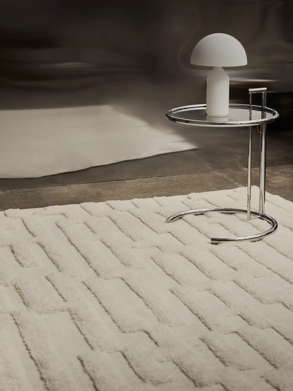 Tinted Objects Bielke Wool Rug, a luxurious cream-colored modern area rug with a subtle raised geometric pattern, featuring a plush high pile texture. This elegant rug provides warmth and style, perfect for contemporary living rooms or bedrooms seeking a cozy, sophisticated touch.