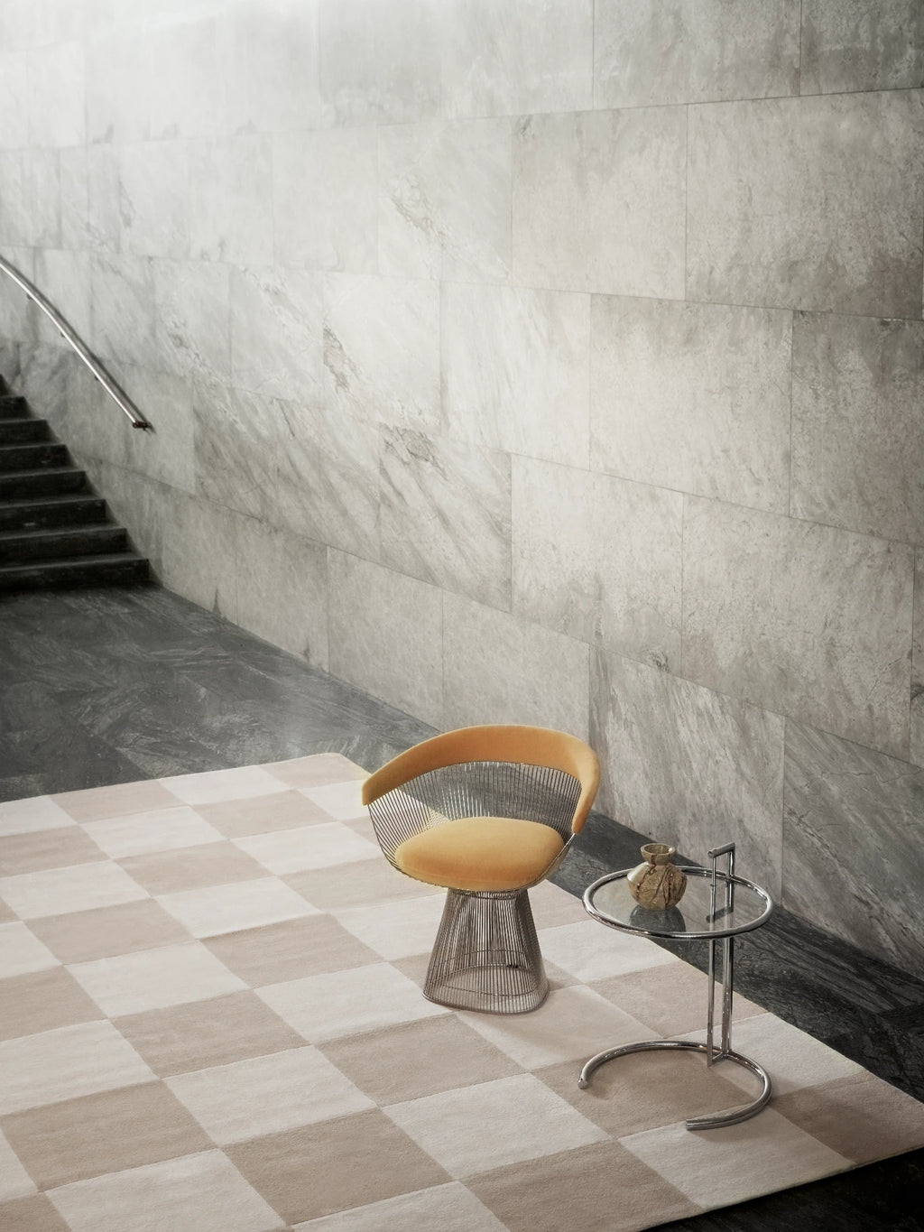 Tinted Objects Hafstrom Wool Rug, featuring a checkerboard pattern with alternating light beige and cream squares. This luxurious, soft texture rug is perfect for adding warmth and a modern aesthetic to contemporary living spaces or entryways.