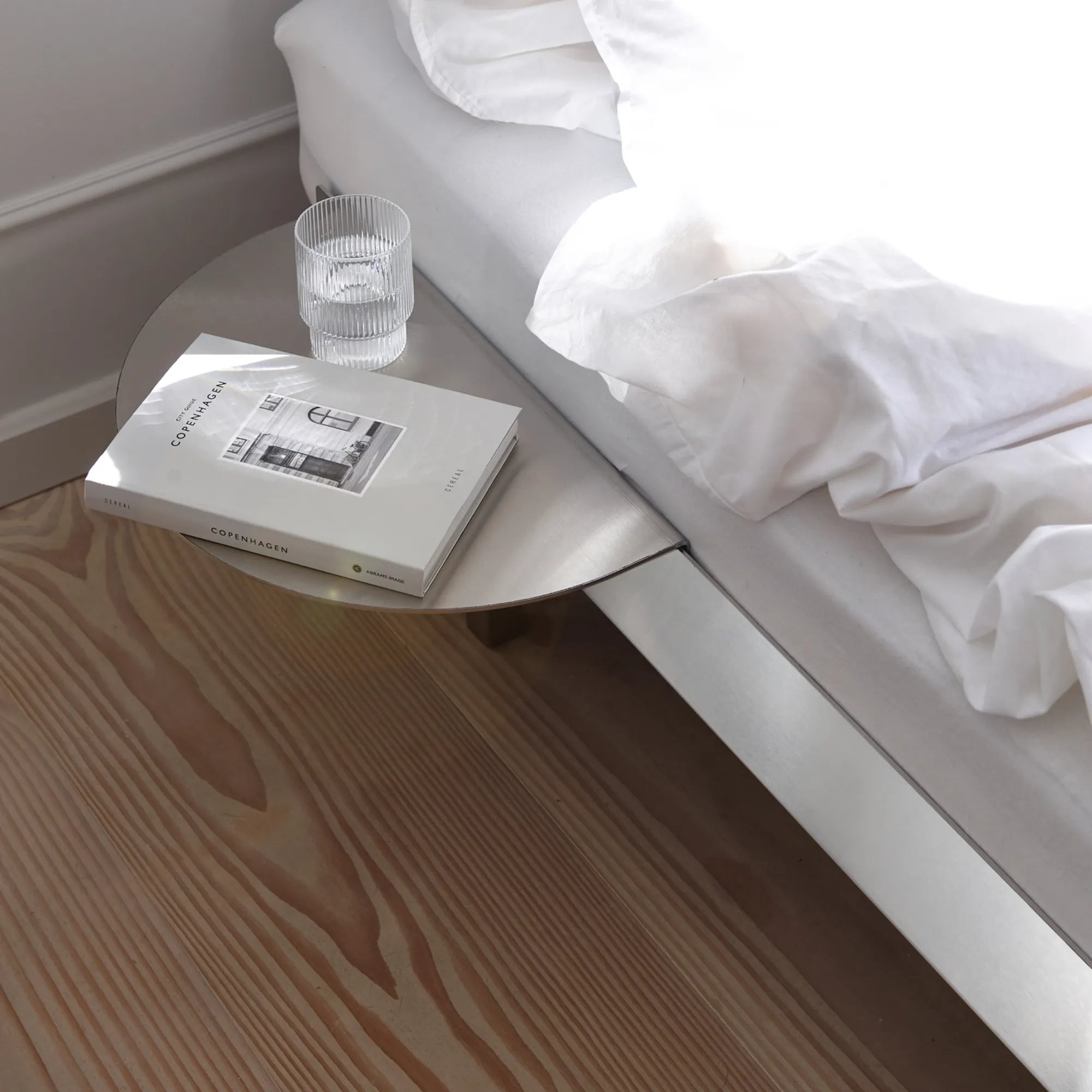  Minimalist stainless steel bed frame with low profile and industrial-inspired design