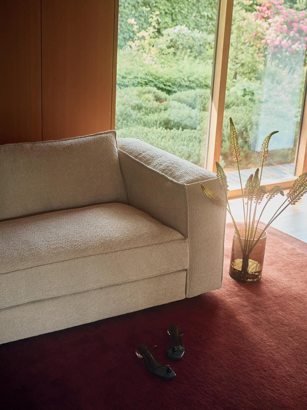 Tinted Objects Klinge Sofa, a luxurious cream-colored boucle sofa with a modern silhouette, featuring plush textured fabric and clean lines. This elegant comfortable sofa is perfect for contemporary living rooms and stylish home decor enthusiasts.