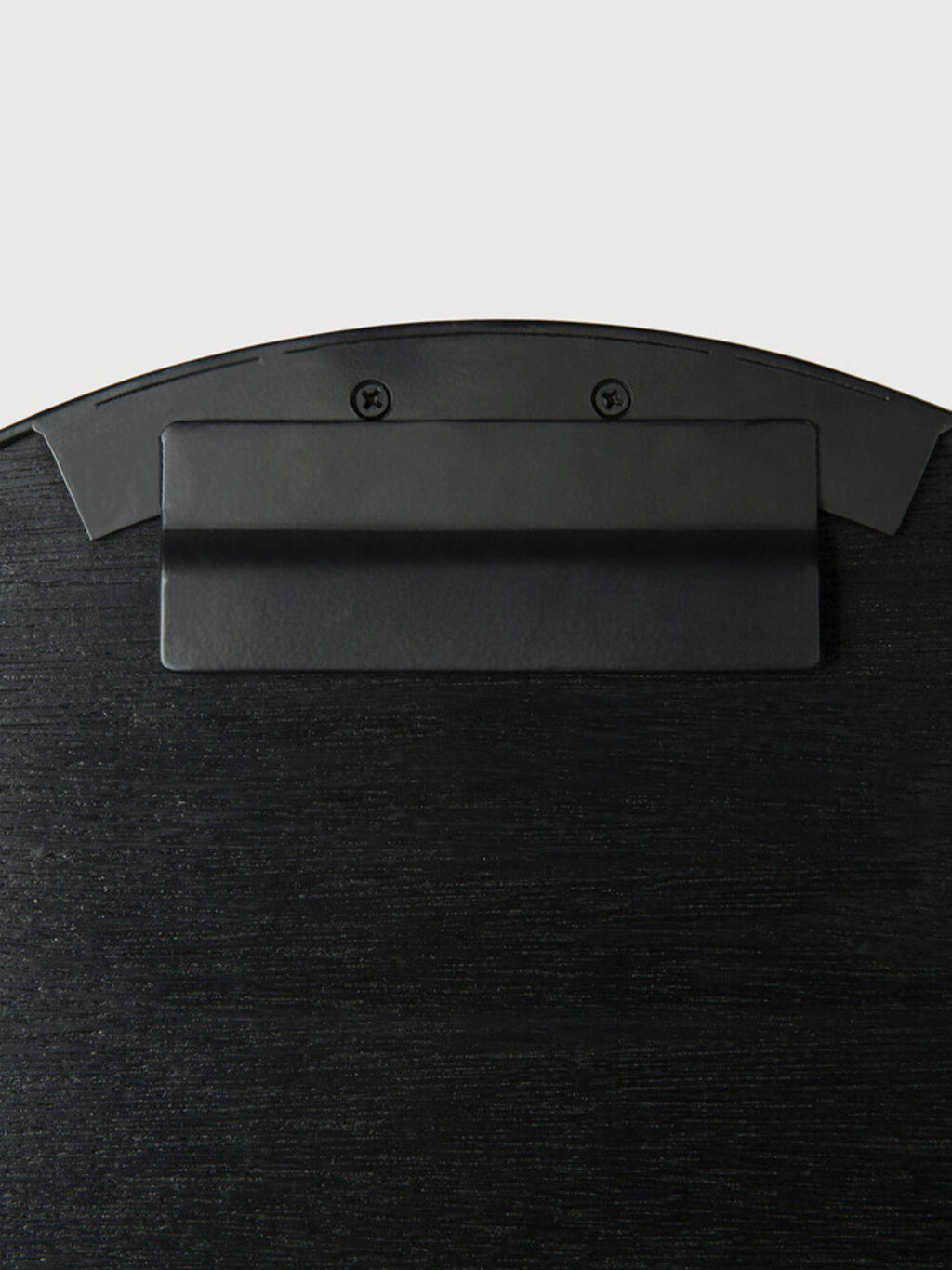 Ethnicraft Layered Clay Wall Art, featuring a matte black metal mounting bracket secured with screws to a deep charcoal textured backing, displaying a subtle horizontal wood-effect grain and a gently curved top edge.