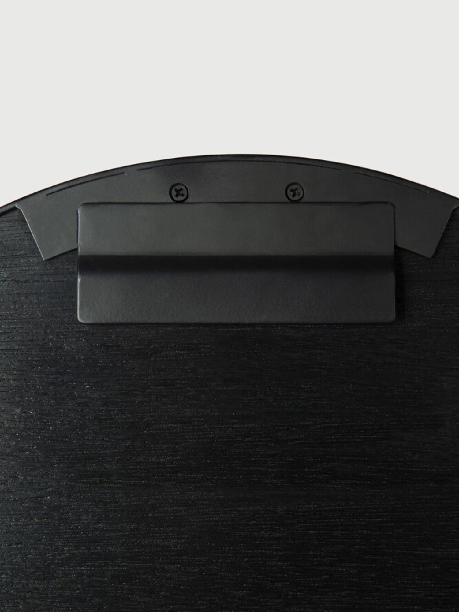 Ethnicraft Layered Clay Wall Art, featuring a matte black metal mounting bracket secured with screws to a deep charcoal textured backing, displaying a subtle horizontal wood-effect grain and a gently curved top edge.