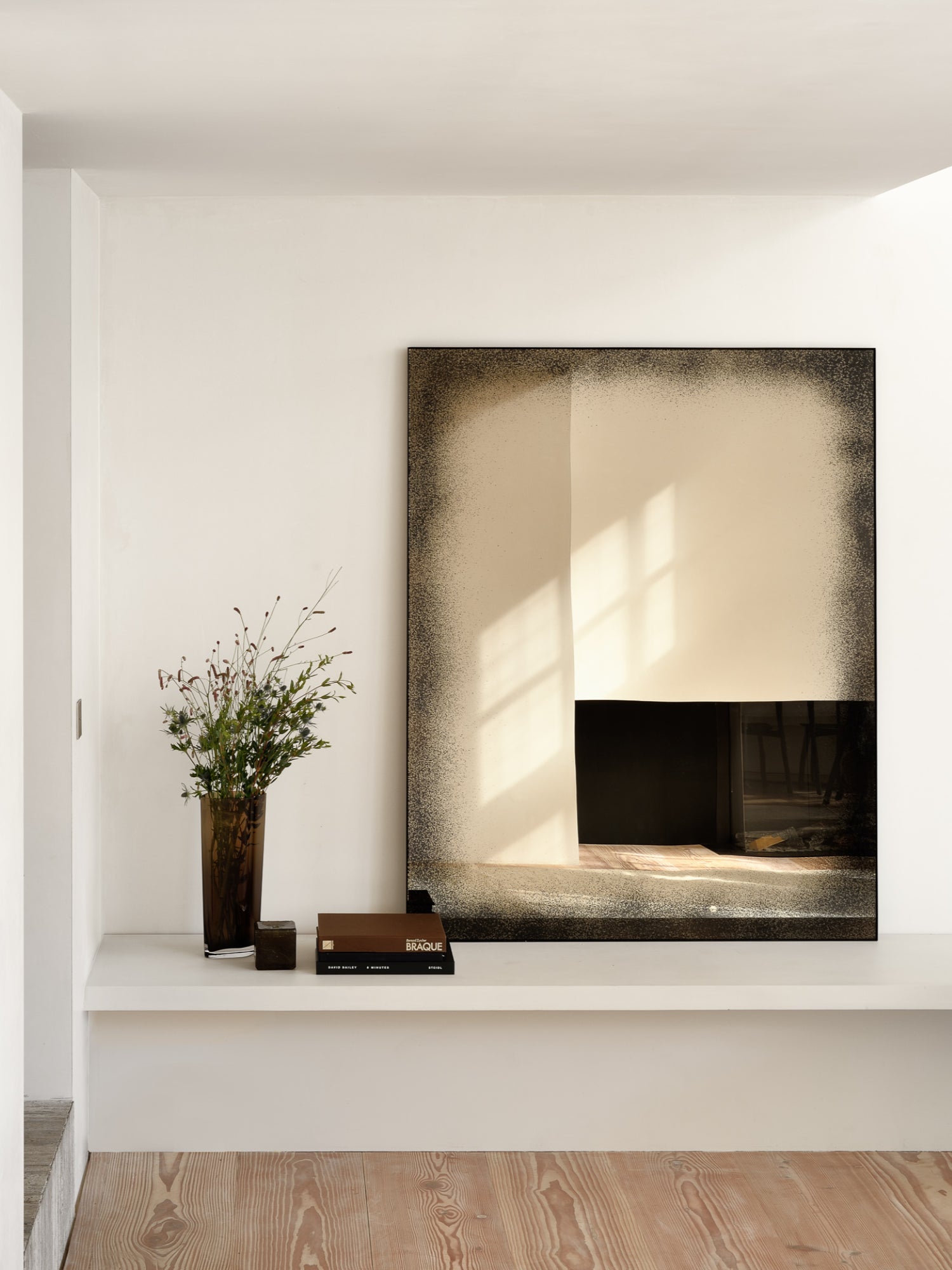 Ethnicraft Aged Wall Mirror, a rectangular decorative wall mirror featuring a unique distressed antique mirror glass effect with dark, speckled, almost smoky borders that gradually fade into a clear, reflective center.