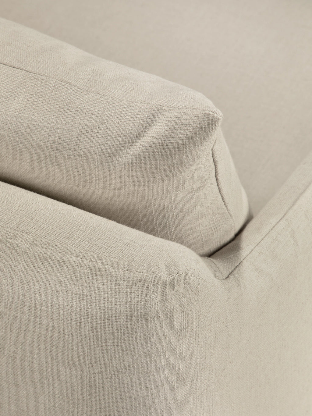 Ethnicraft Weave Lounge Chair, a close-up of a plush, natural beige lounge chair upholstered in a textured linen-blend fabric. It features soft, inviting cushions with subtle piping details, showcasing an organic modern aesthetic. Perfect as a comfortable accent chair for contemporary living rooms, minimalist bedrooms, or cozy reading nooks.