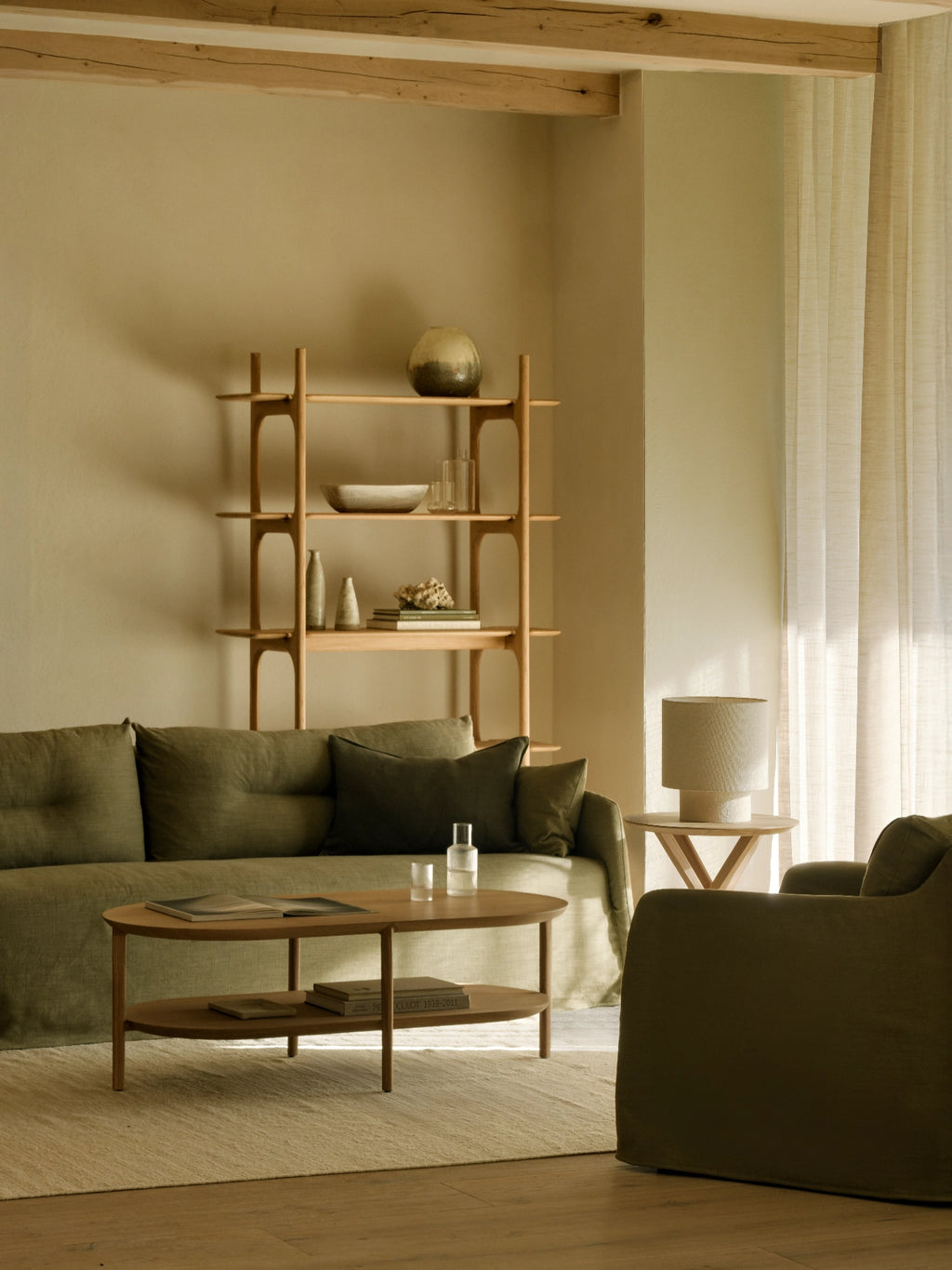 Ethnicraft Weave Sofa, an olive green sofa upholstered in a softly textured natural linen blend fabric with deep seating and generous, relaxed proportions. This organic modern sofa features tufted cushions and a low-profile design, perfect for contemporary living rooms or cozy modern spaces.