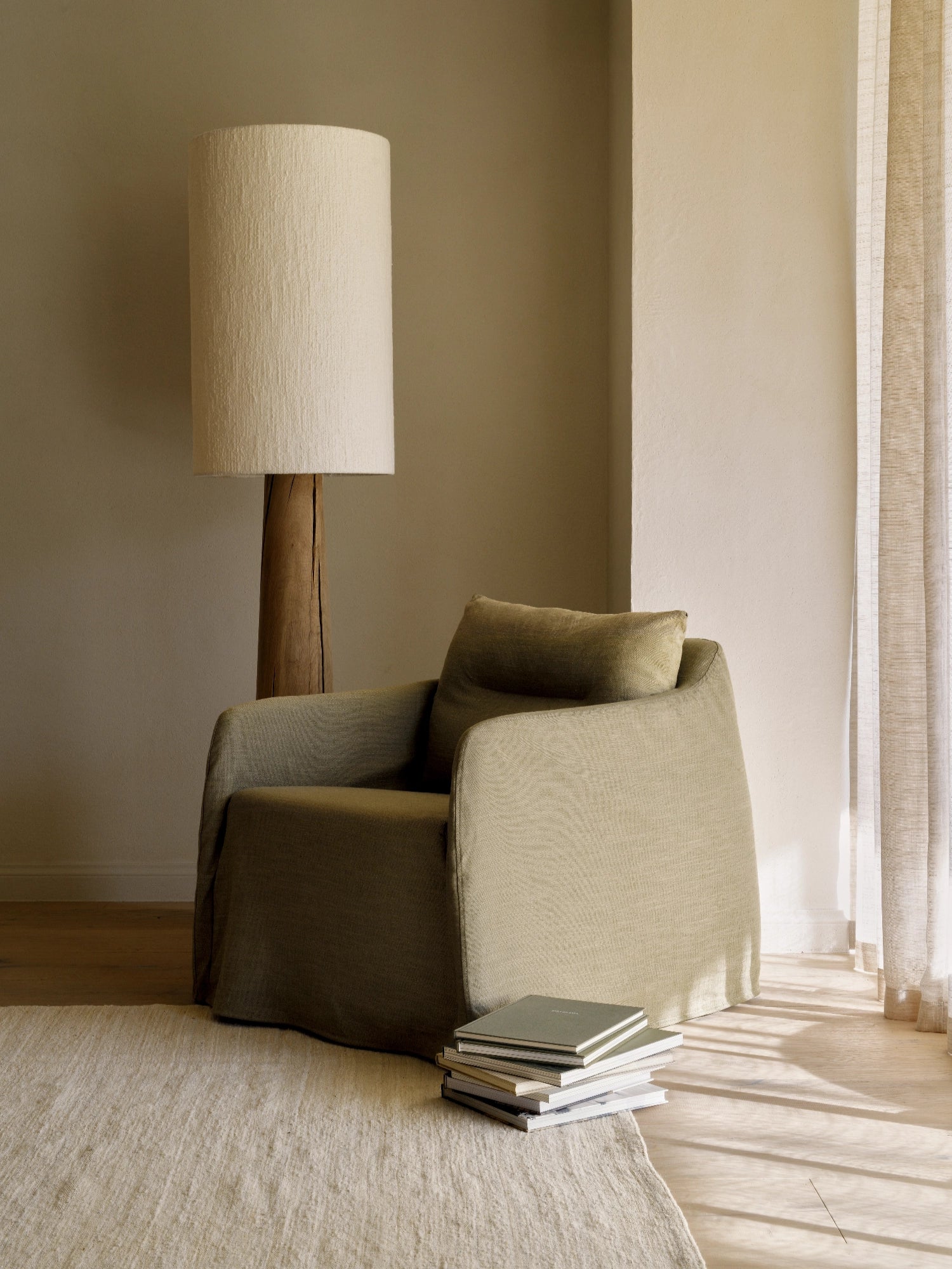 Ethnicraft Weave Lounge Chair, a comfortable organic modern armchair upholstered in a textured khaki green woven fabric with a relaxed, inviting slipcover design and plush cushions.