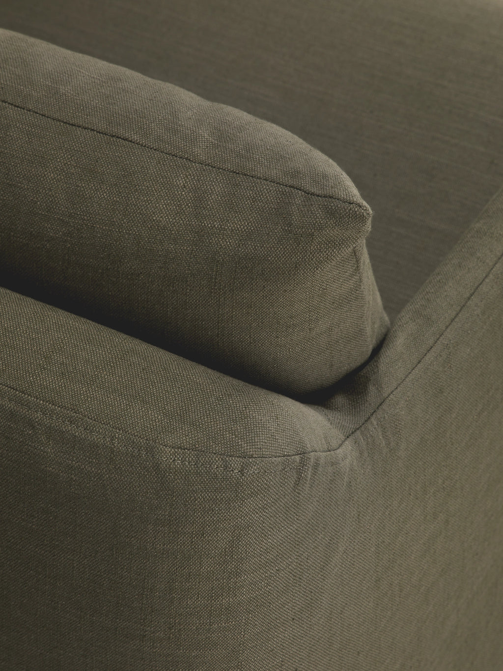 Ethnicraft Weave Lounge Chair, a deep olive green lounge chair featuring a plush, inviting cushion and armrest upholstered in a durable, subtly textured woven fabric with neat piping details.