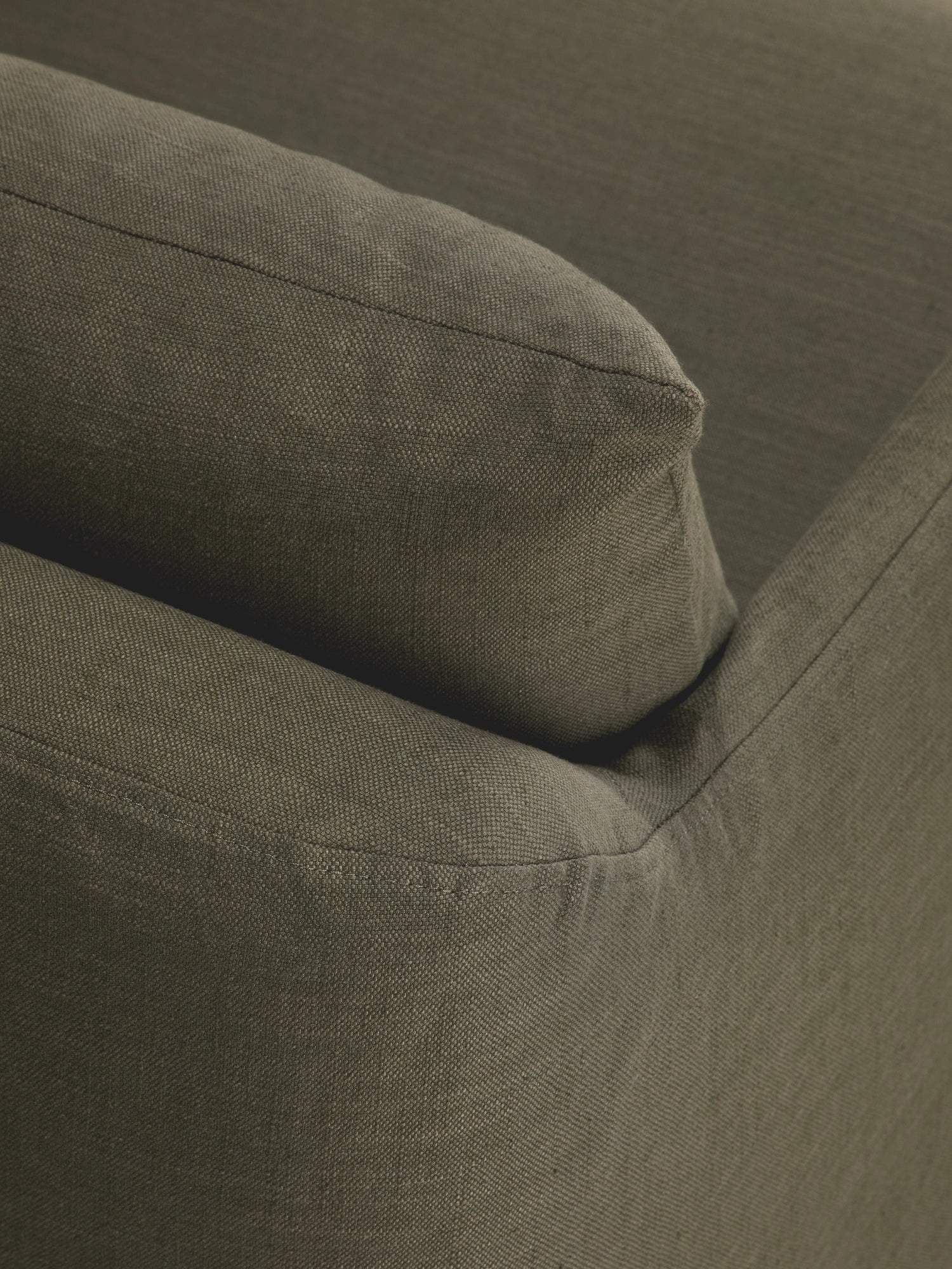 Ethnicraft Weave Lounge Chair, a deep olive green lounge chair featuring a plush, inviting cushion and armrest upholstered in a durable, subtly textured woven fabric with neat piping details.