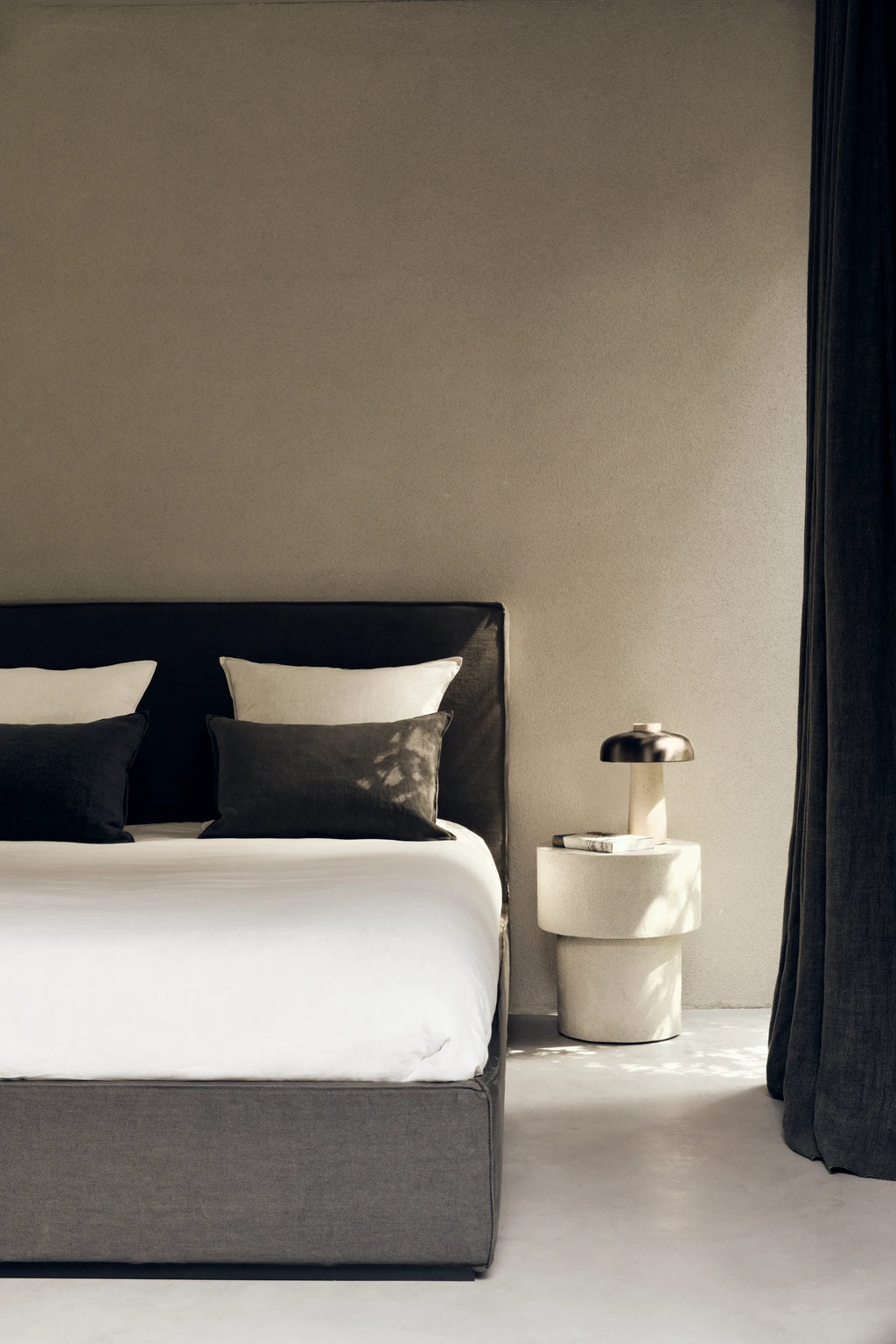 Ethnicraft Elements Side Table, a geometric sculptural side table crafted from light cream textured plaster with a matte, concrete-like finish. It features a unique stacked cylindrical design, creating a raw, organic modern aesthetic with clean lines.