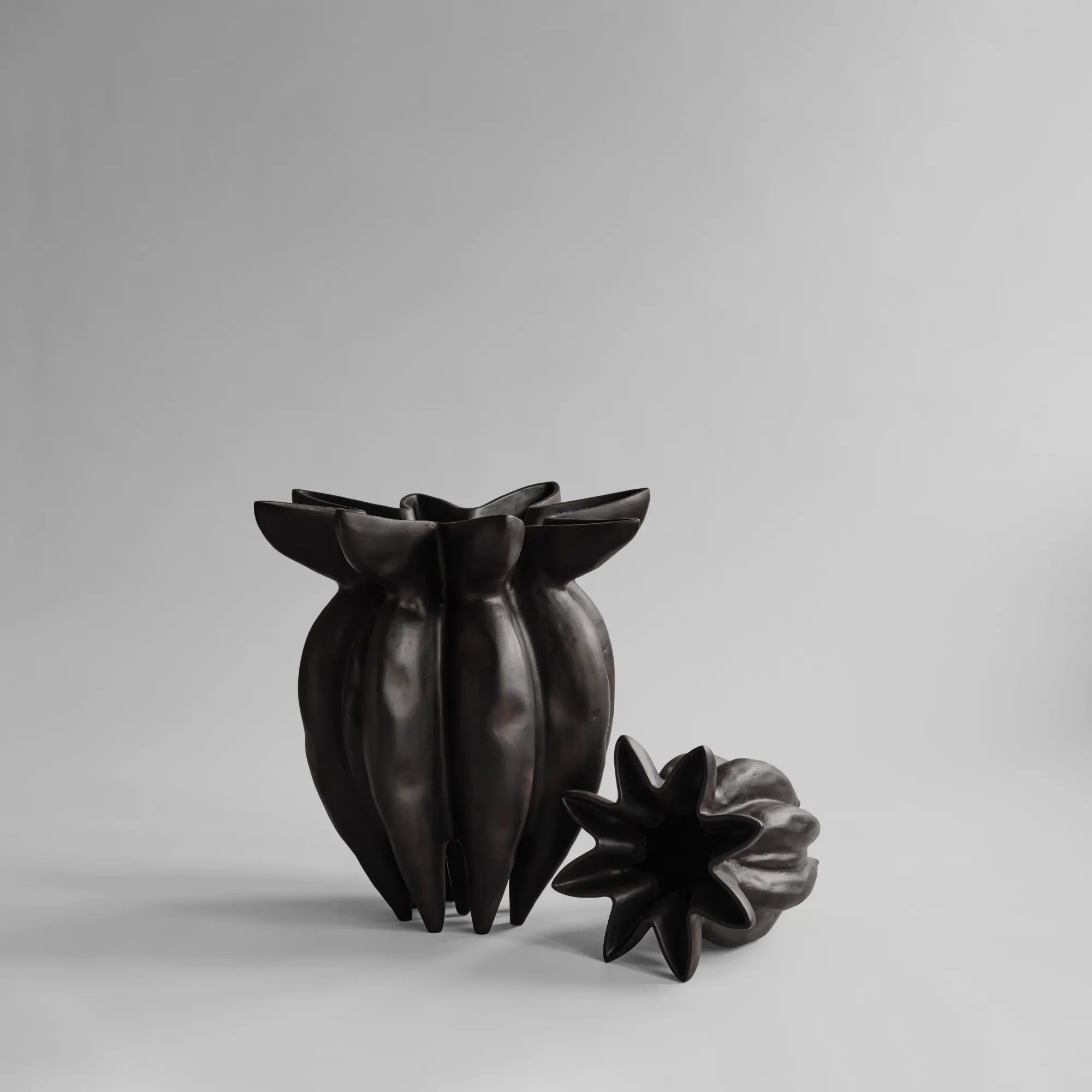 A small, elegant lotus flower inspired ceramic vase in white