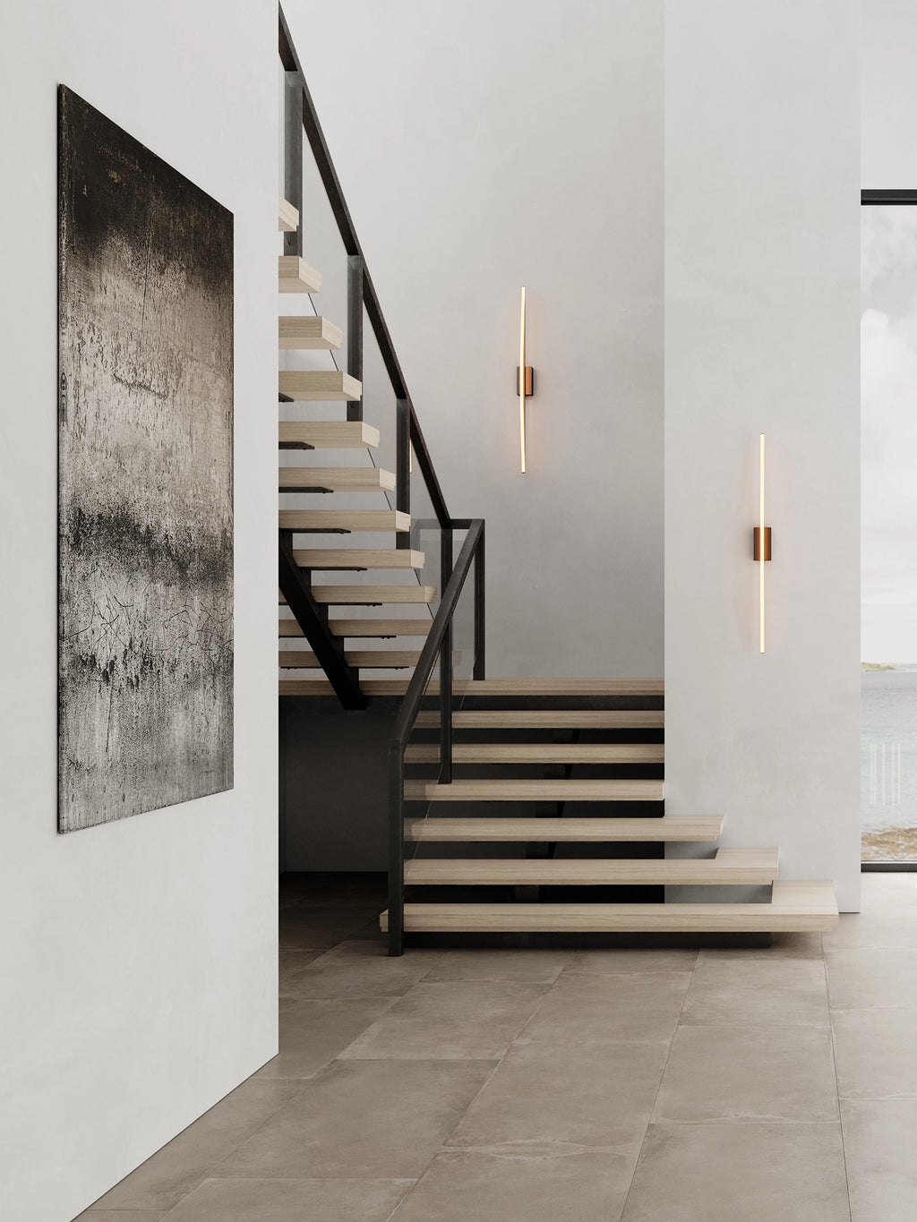 101 CPH Bow Wall Lamp: Two sleek, modern brass-accented wall sconces with warm linear LED lights in a contemporary staircase setting. Ideal for premium interior lighting.