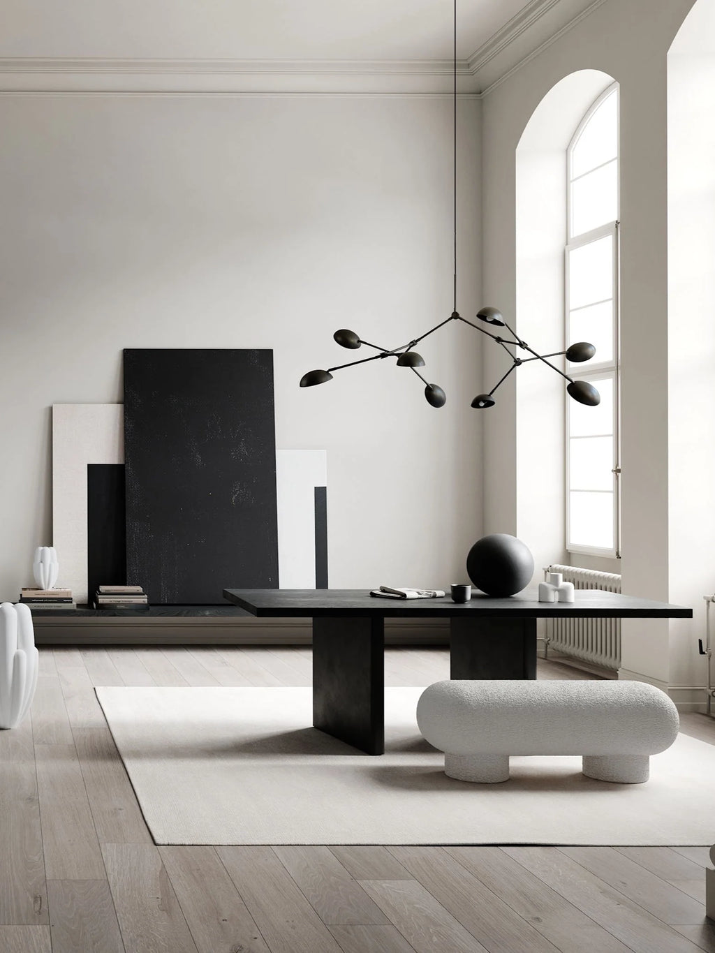 101 CPH Petit Big Foot Bench - Boucle. A stylish off-white textured boucle bench with rounded edges and thick cylindrical legs, displayed on a light rug in a modern living space. This premium designer furniture is ideal for adding unique seating to any room.