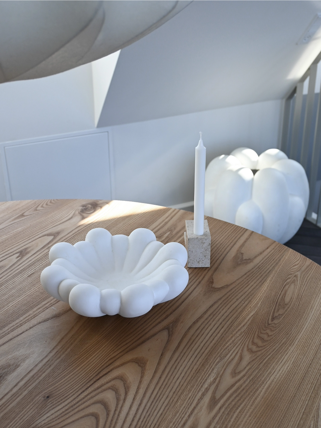 101 CPH Bloom Tray in a creamy matte white finish, shaped like a flower bloom with distinct petal-like segments, displayed on a light wooden table. A premium decorative piece for modern interior styling.