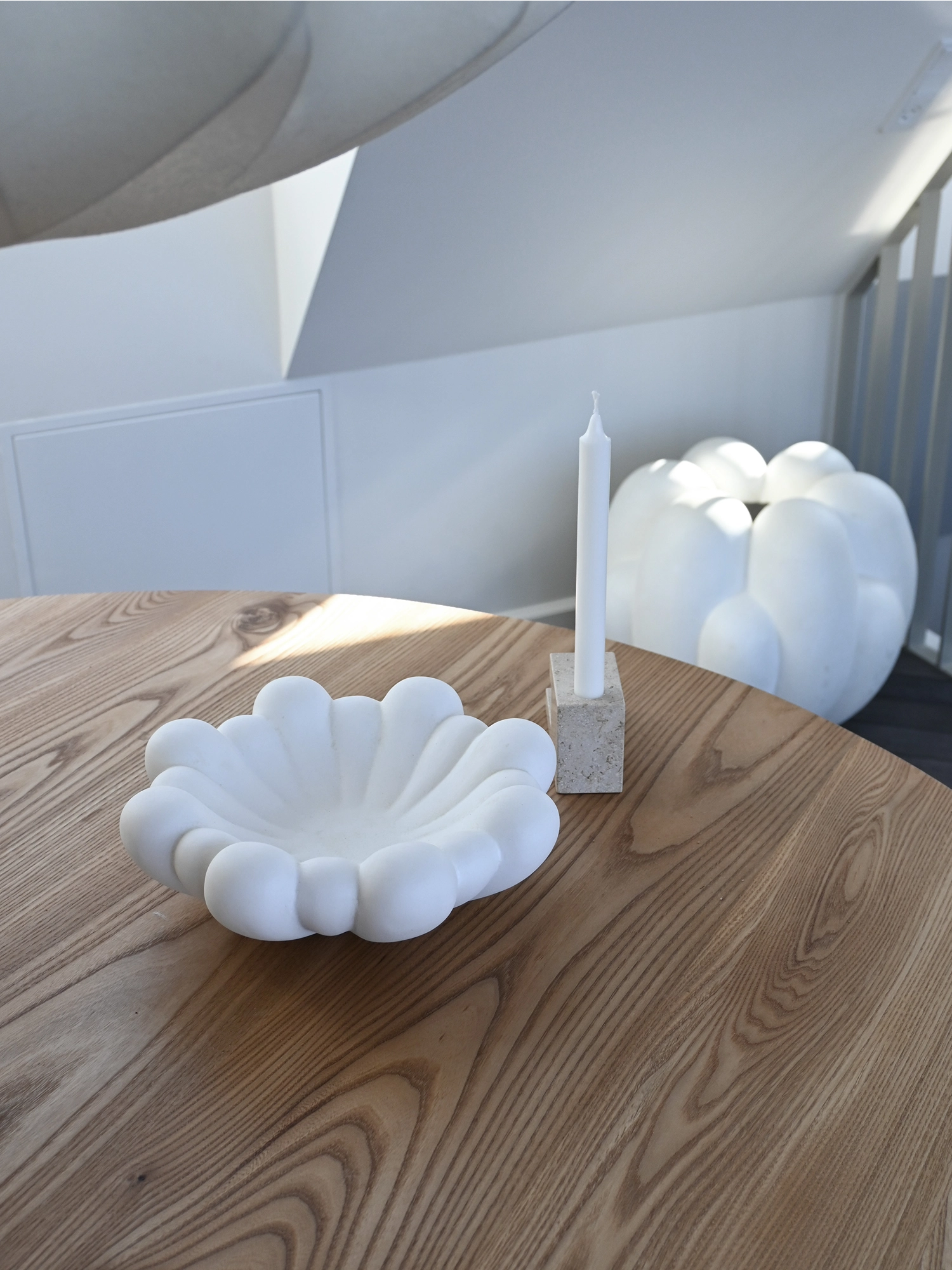101 CPH Bloom Tray in a creamy matte white finish, shaped like a flower bloom with distinct petal-like segments, displayed on a light wooden table. A premium decorative piece for modern interior styling.