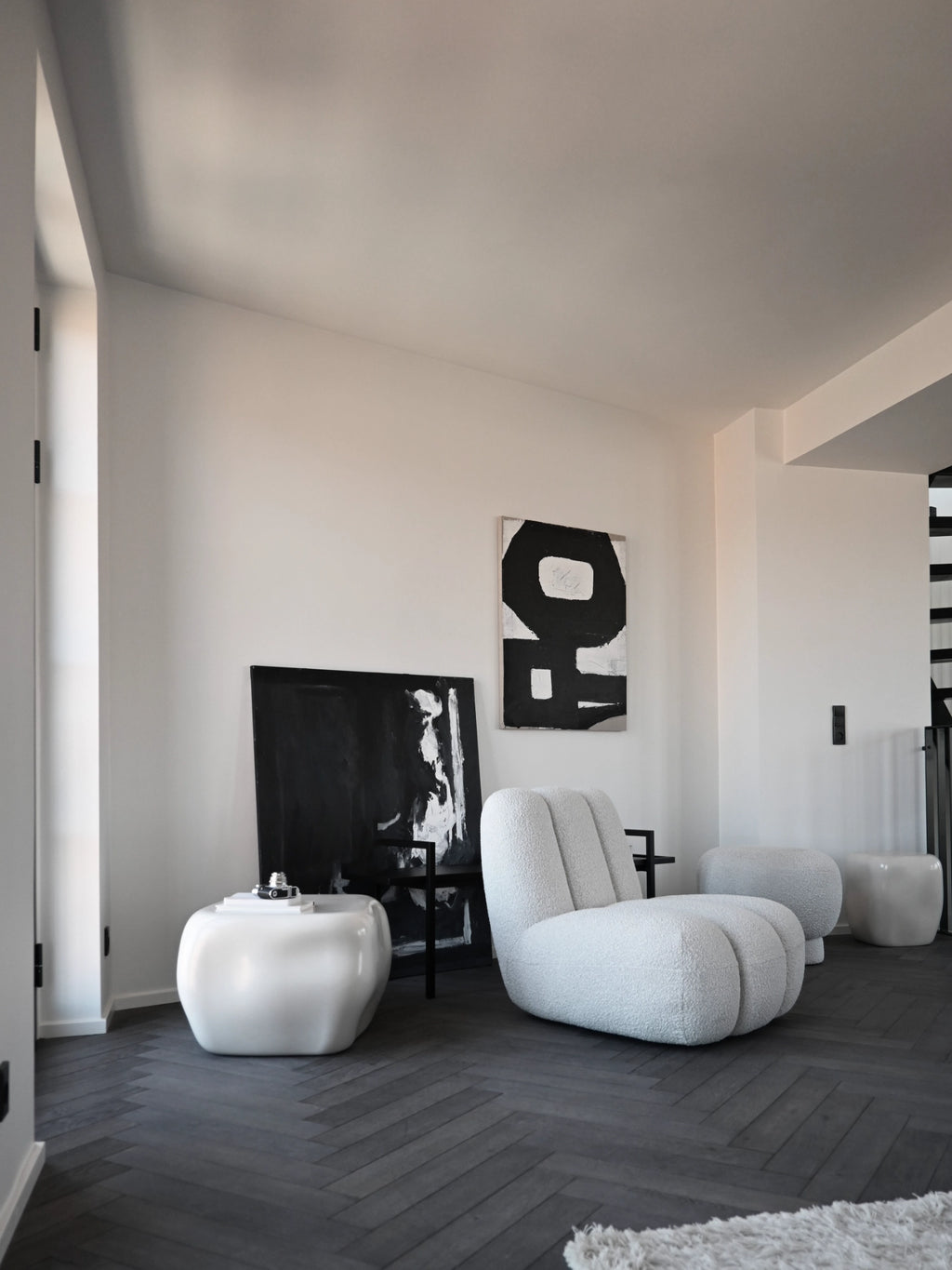 101 CPH Ishi Coffee Table - Ceramic. Organic-shaped, glossy white ceramic designer coffee table used in a modern living room setting. A luxury statement piece for contemporary interiors.