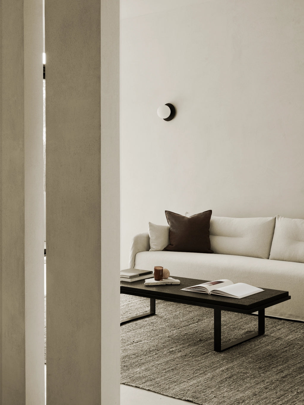 Ethnicraft Weave Sofa, a modern minimalist sofa featuring plush, textured cream fabric upholstery and clean, organic lines with a gently rounded armrest. This contemporary off-white sofa offers deep seating for a comfortable yet stylish look. Perfect for Scandinavian living rooms, organic modern interiors, or minimalist spaces.