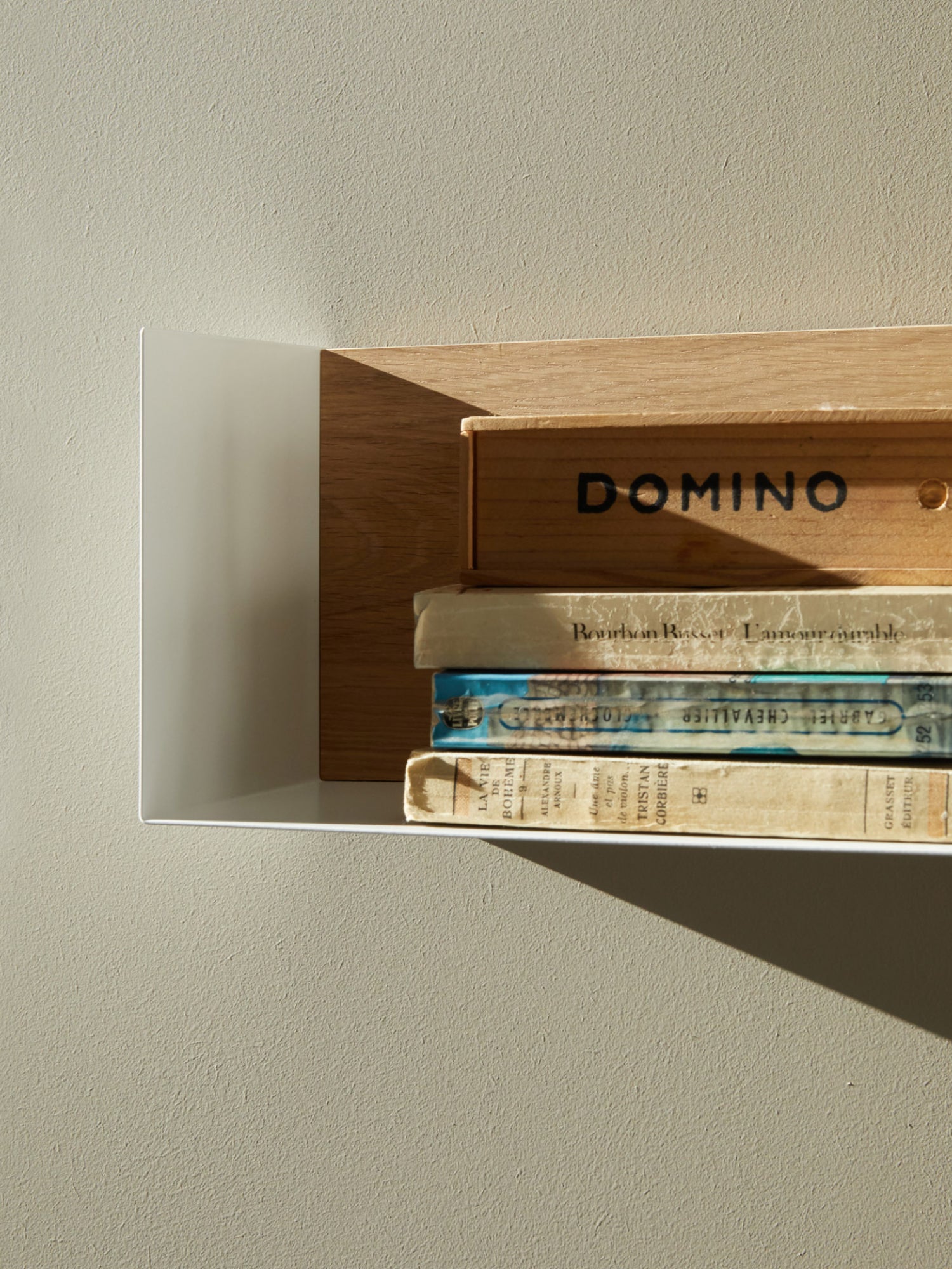 Ethnicraft U Shelf, a modern minimalist wall shelf featuring a clean white metal U-shaped frame and a warm natural oak wood back panel. This contemporary floating shelf offers a sleek design with contrasting materials, perfect for Scandinavian living rooms, minimalist home offices, or bedroom accent styling.