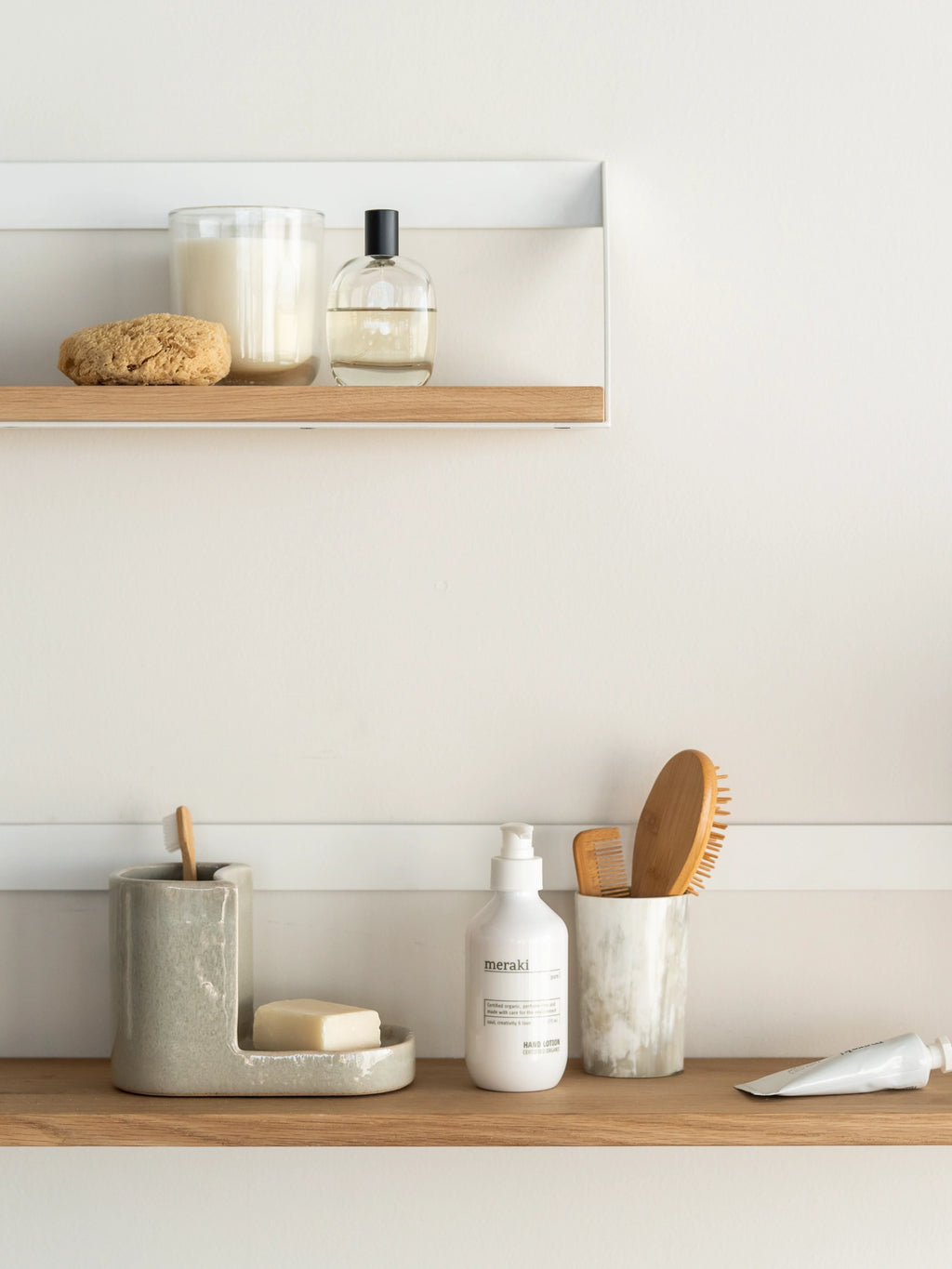 Ethnicraft Wall Shelf, a sleek modern minimalist floating shelf featuring a natural solid oak wood board encased by a clean white powder-coated metal frame. This Scandinavian-inspired wall-mounted storage solution offers a contemporary design for organizing essentials in a clean aesthetic. Perfect as a bathroom shelf, bedside accent, or for minimalist shelf styling in any modern living space.