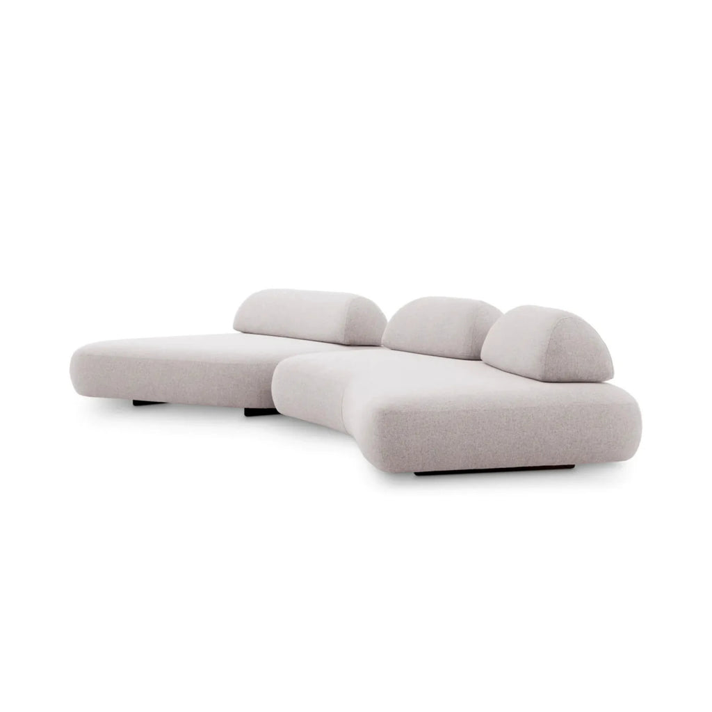 Eichholtz Residenza Outdoor Sofa, a contemporary organic modern modular sofa featuring a light greige textured outdoor performance fabric upholstery with a low-profile, curved silhouette and two distinct backrest cushions, supported by a sleek black base. This all-weather luxury outdoor lounge seating is perfect for sophisticated patios, modern garden designs, and poolside living spaces.