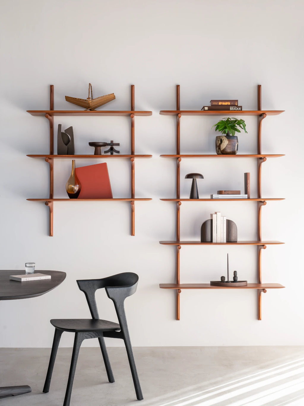 Ethnicraft PI Wall Shelf, a mid-century modern wall shelving unit crafted from warm reddish-brown solid wood, featuring elegantly curved, organic supports and minimalist floating shelves.