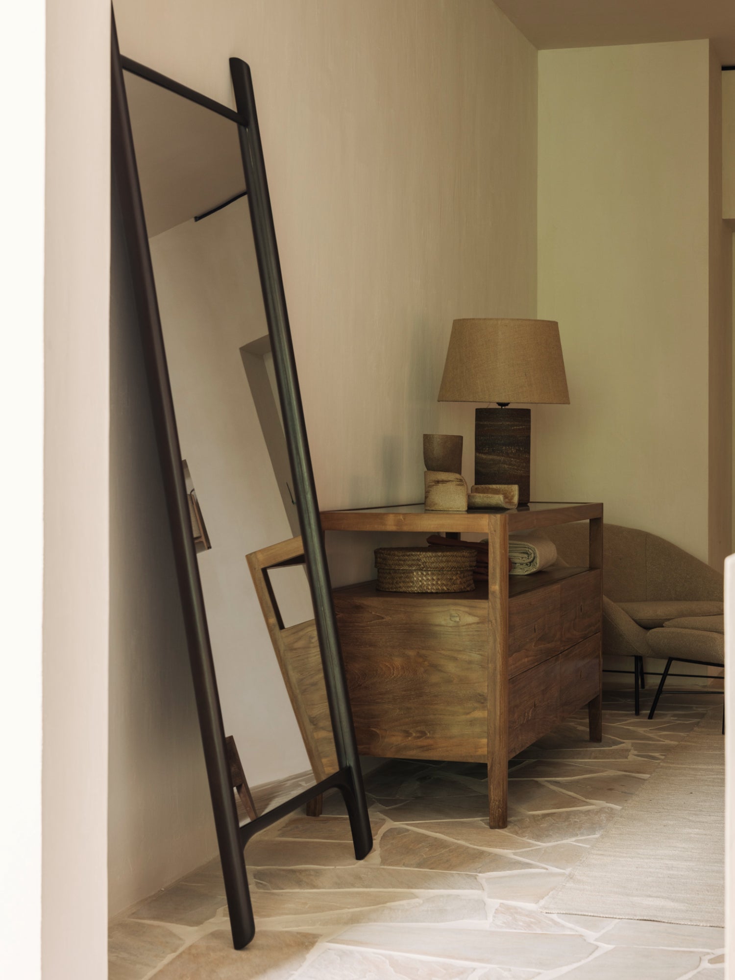 Ethnicraft PI Floor Mirror, a modern minimalist full-length mirror featuring a sleek dark solid wood frame that leans elegantly against the wall. Its unique A-frame design in rich, deep brown wood offers a contemporary standing mirror solution with clean lines. Perfect as a designer entryway mirror or a stylish bedroom accent in organic modern and contemporary interiors.