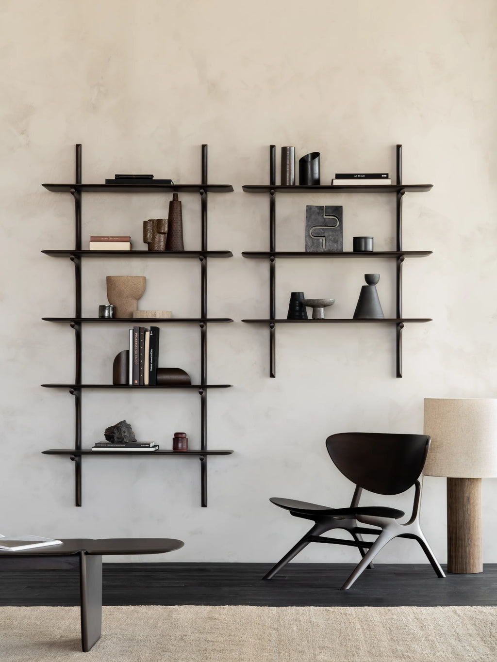 Ethnicraft PI Wall Shelf, a dark solid oak wall-mounted shelving unit featuring a modern minimalist design with sleek, rounded-edge shelves and architectural vertical supports. This contemporary dark wood display shelf is perfect for organic modern living rooms, home offices, or bedroom shelf styling.