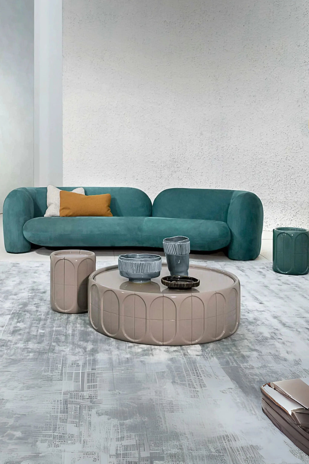 Hessentia Gio Curved Sofa, a luxurious organic modern sofa upholstered in a rich teal velvet fabric, featuring a distinctive low-profile and a sculptural, continuous curved silhouette. This contemporary modular sofa offers plush, deep seating, perfect for creating a statement living room or a sophisticated lounge area.