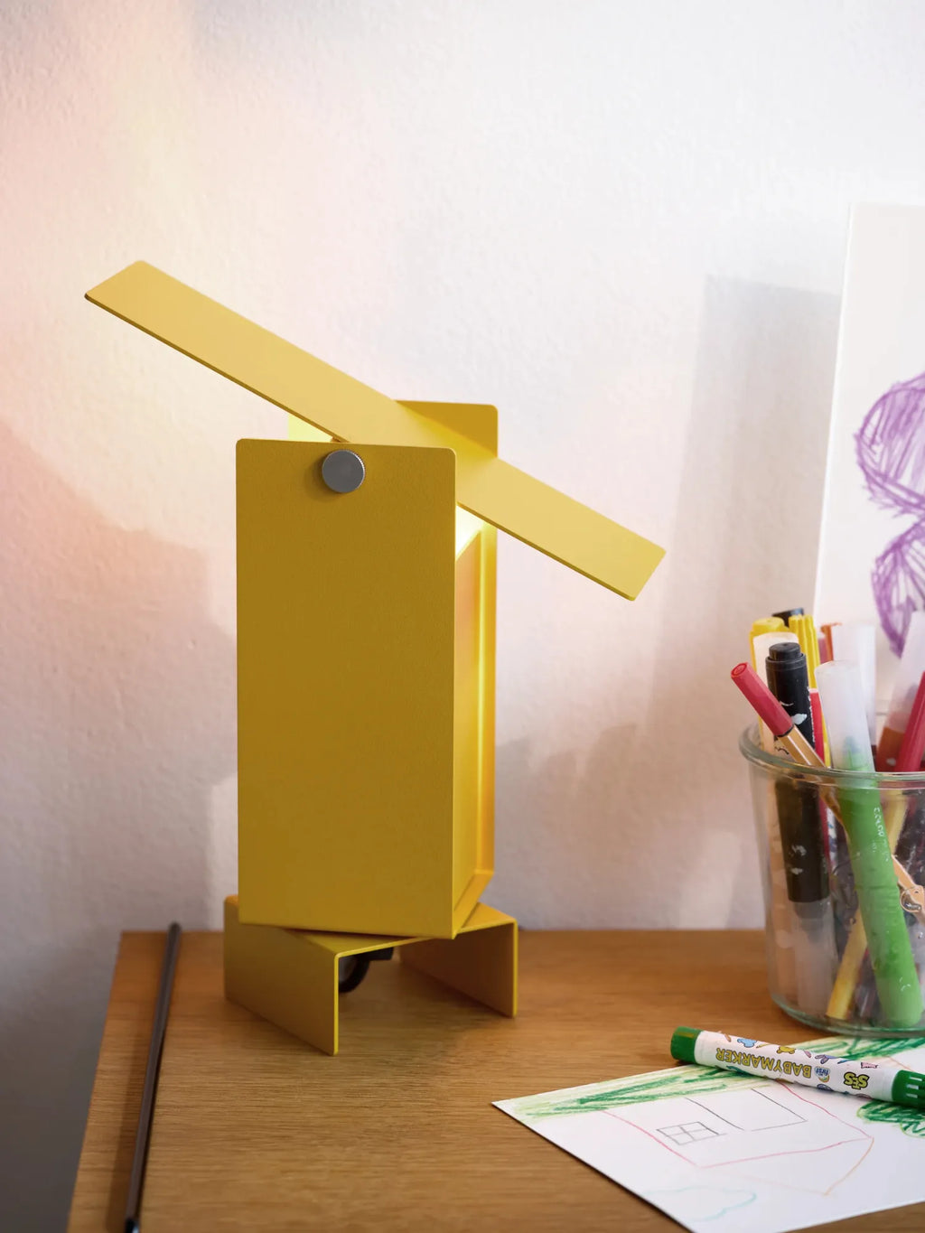 MOEBE Pivoting Table Lamp, a striking modern minimalist table lamp crafted from matte yellow powder-coated steel, featuring a geometric rectangular base and body with a long, flat pivoting arm. Its unique design includes a magnetic pivot point allowing the light to be directed precisely. This industrial chic desk lamp is perfect for a contemporary home office, Scandinavian study space, or as a vibrant accent in a modern living room.