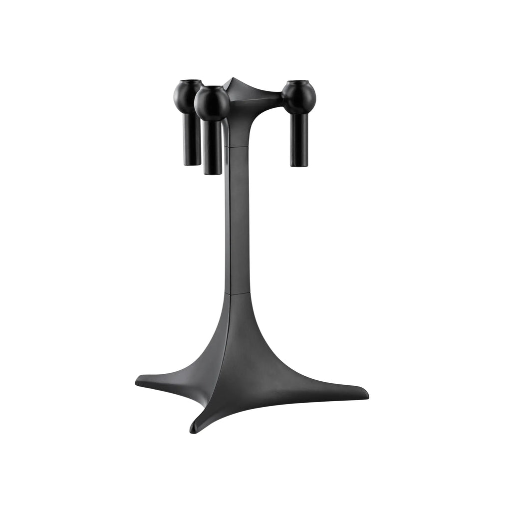 Stoff Nagel Candle Holder Stand, a striking matte black metal candelabra with a distinctive brutalist and mid-century modern design, featuring a geometric star-shaped base, a tall central column, and three sculptural arms with spherical candle cups. This contemporary black candle holder is perfect as a statement dining table centerpiece or for elegant shelf styling in a modern living room.
