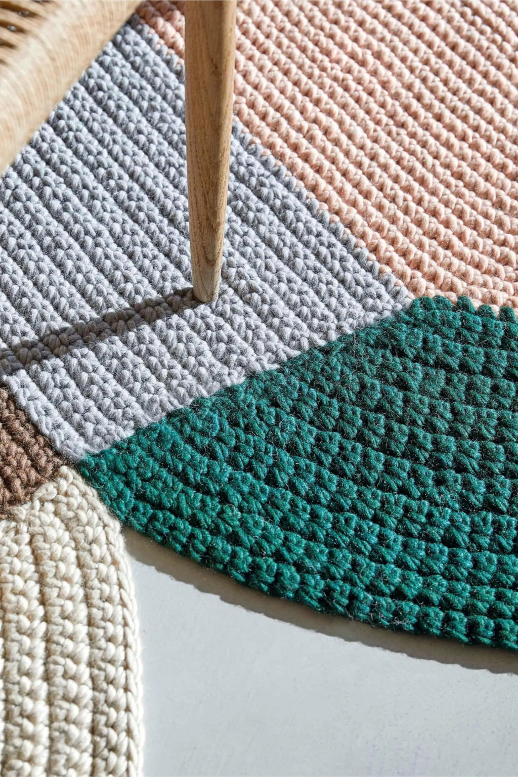 GAN Rugs Mono Blue Rug, a vibrant multi-color patchwork area rug featuring a chunky hand-crocheted texture in soft natural fibers like wool or cotton.