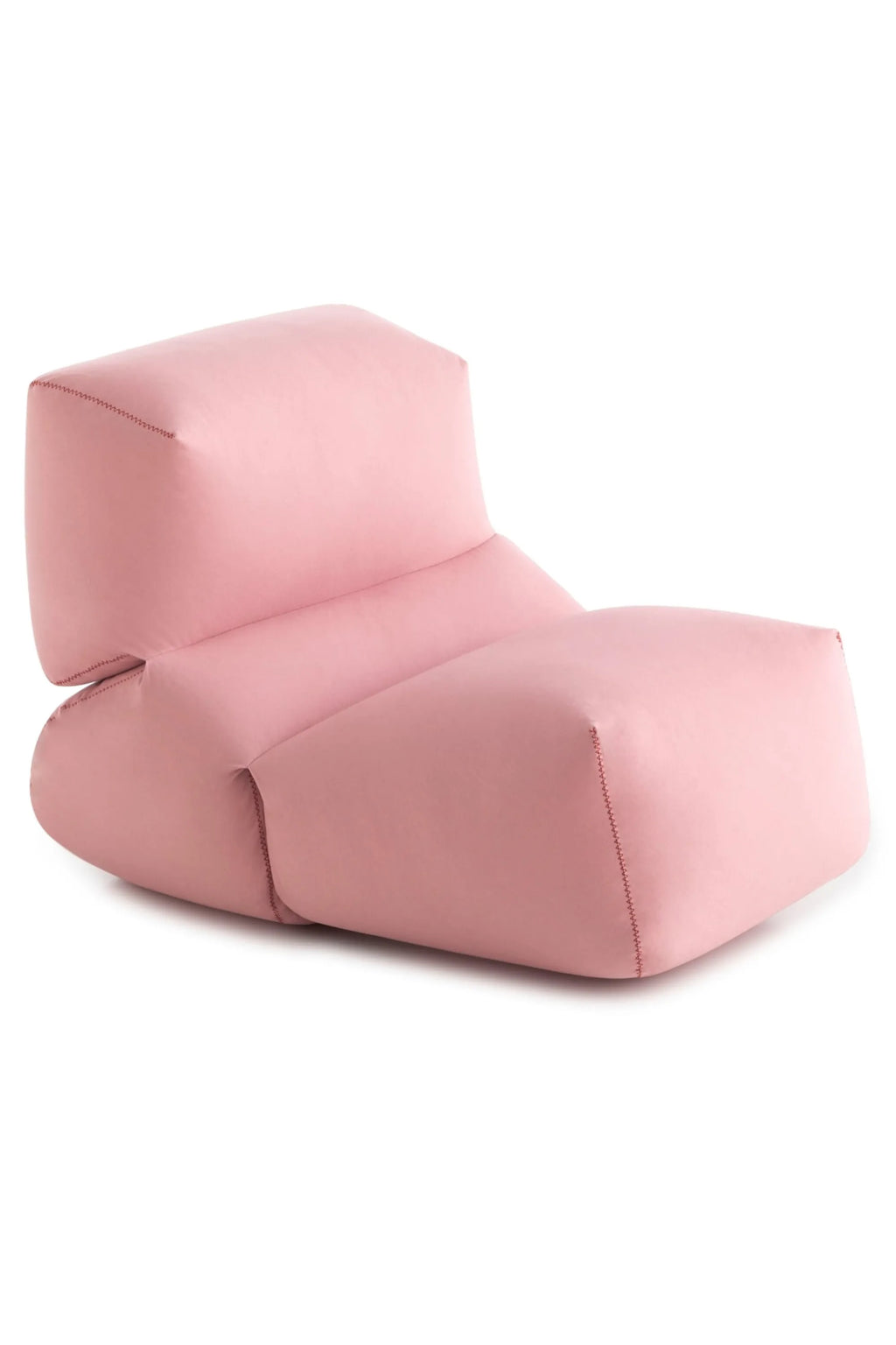 GAN Rugs Grapy Lounge Chair, a plush, low-profile lounge chair upholstered in a soft, muted blush pink fabric, featuring distinctive visible zigzag stitching along its organic, modular shape. This contemporary floor chair provides relaxed, comfortable seating. Perfect for casual living rooms, modern bedrooms, or cozy reading nooks.