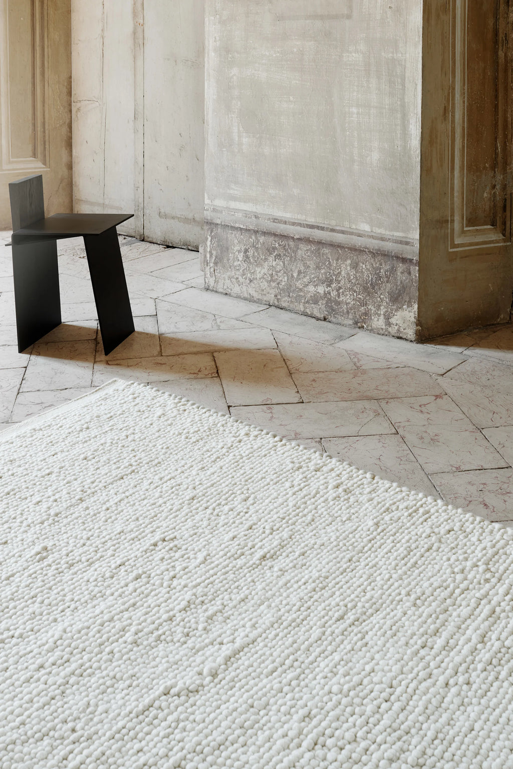 Linie Design Flavia Wool Rug, a plush cream hand-knotted wool area rug featuring a distinctive chunky textured loop pile, offering a cozy and inviting feel. This natural off-white wool rug is ideal for adding warmth and Scandinavian style to minimalist living rooms, cozy bedrooms, or organic modern spaces.