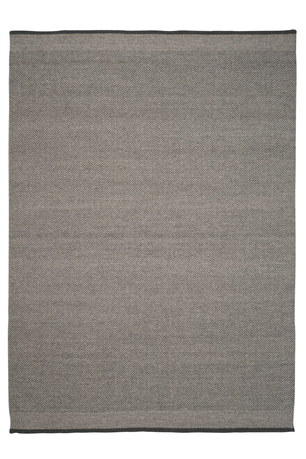 Linie Design Stratum Echo Wool Rug, a modern grey hand-woven wool rug featuring a distinctive herringbone pattern crafted from varying shades of light and dark grey yarns, finished with a subtle darker grey border. This durable flat-weave area rug is perfect for Scandinavian living rooms, contemporary bedrooms, or minimalist home offices seeking a refined texture.