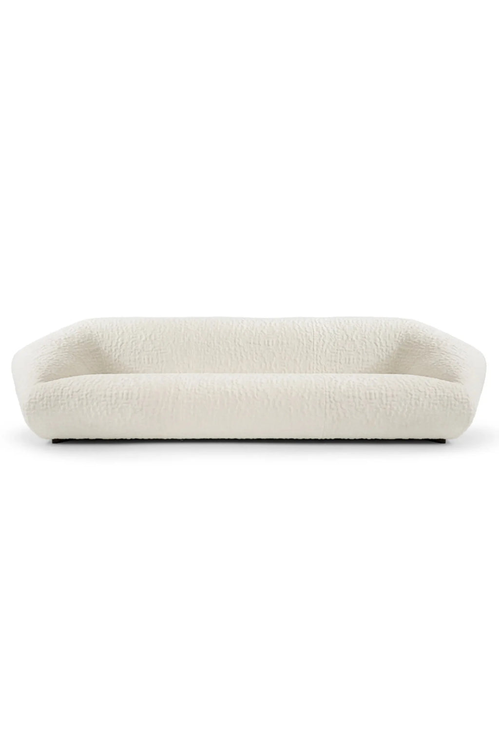Hessentia Bloom Sofa, an organic modern low-profile sofa upholstered in a creamy white bouclé-like textured fabric, featuring a chunky, monolithic silhouette and gently rounded edges. This contemporary sofa is ideal for minimalist living rooms or cozy organic modern interiors seeking soft, inviting design.