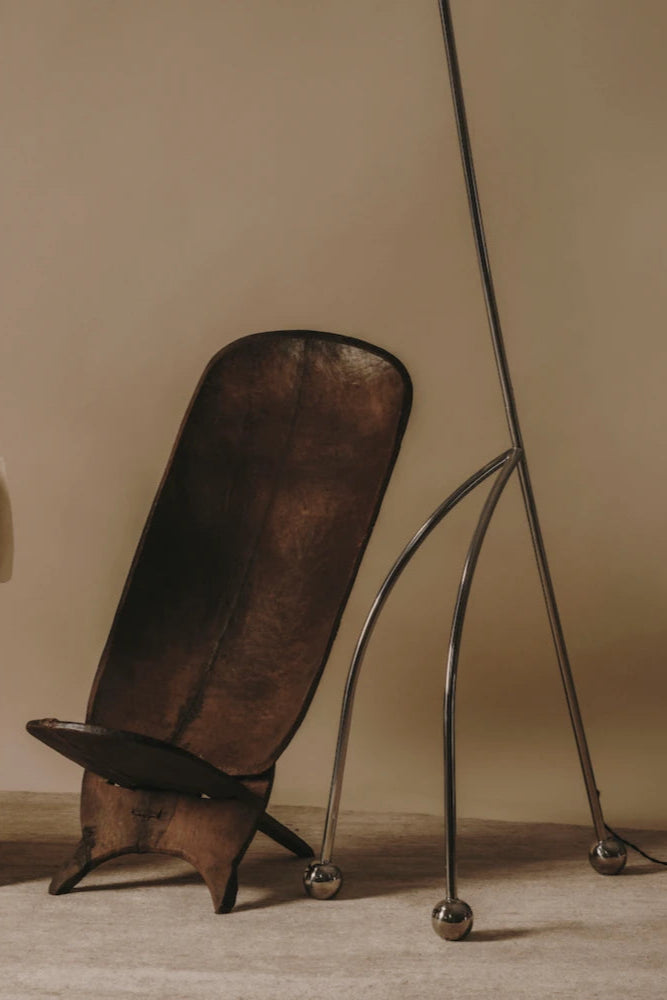 A side view of the Giraffe Lamp showcasing its sleek and stylish silhouette against a neutral backdrop