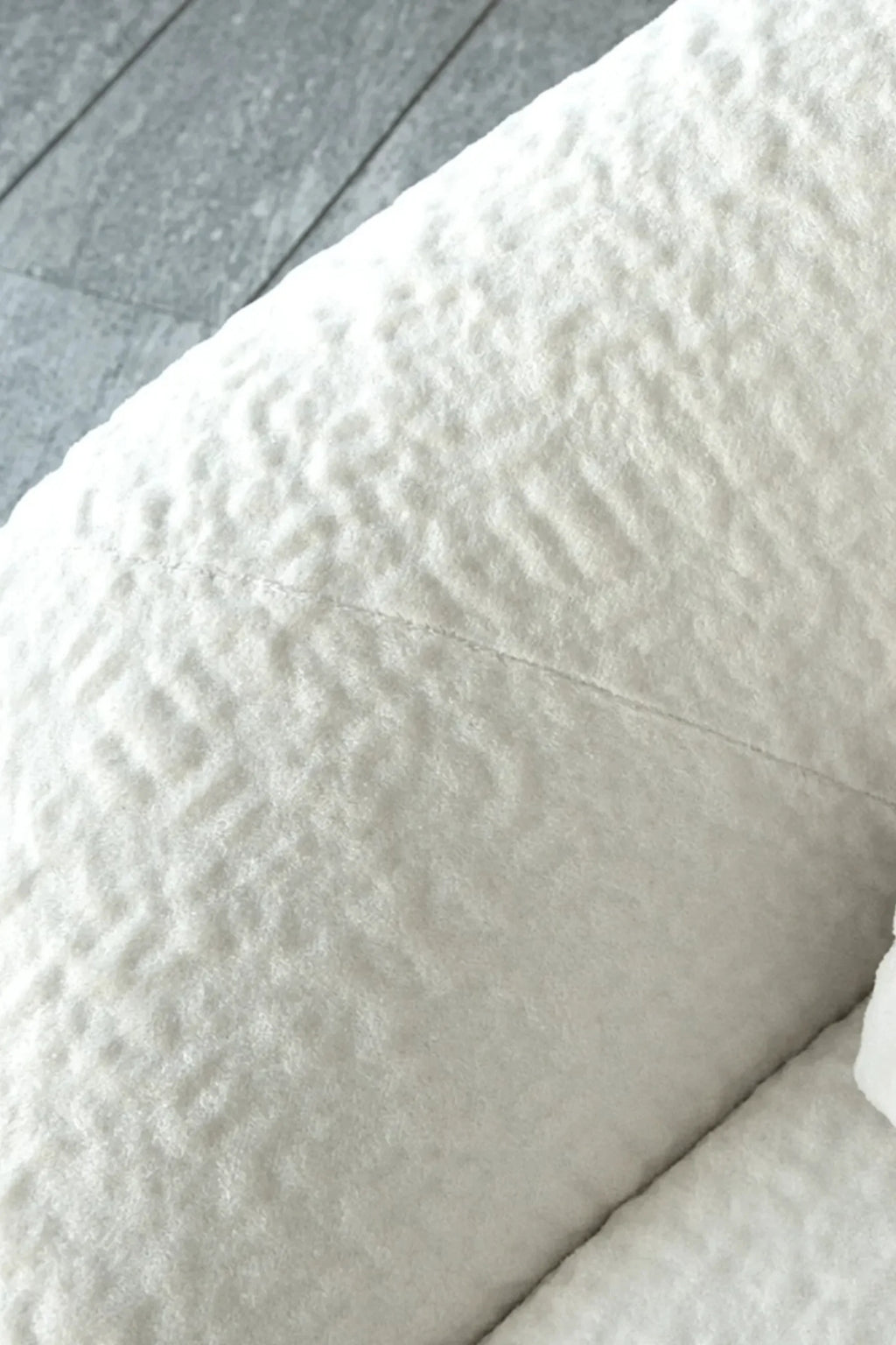 Hessentia Bloom Sofa, a luxurious organic modern lounge sofa upholstered in a rich, textured cream bouclé fabric with a soft, nubby finish and a gently curved, plush silhouette. This contemporary bouclé sofa is ideal for creating a cozy atmosphere in minimalist living rooms, modern apartments, or Scandinavian-inspired interiors.
