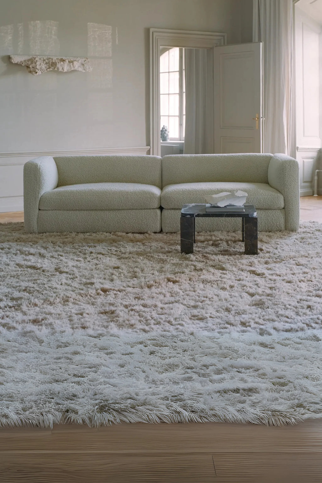 New Works Coda 3-Seater Sofa Configuration 4, a cream bouclé modular sofa featuring a plush, textured fabric and a low-profile, contemporary design with rounded edges. This inviting piece offers deep, comfortable seating in an organic modern style, crafted for relaxation. Ideal for minimalist living rooms or Scandinavian-inspired lounge areas seeking a cozy yet chic aesthetic.