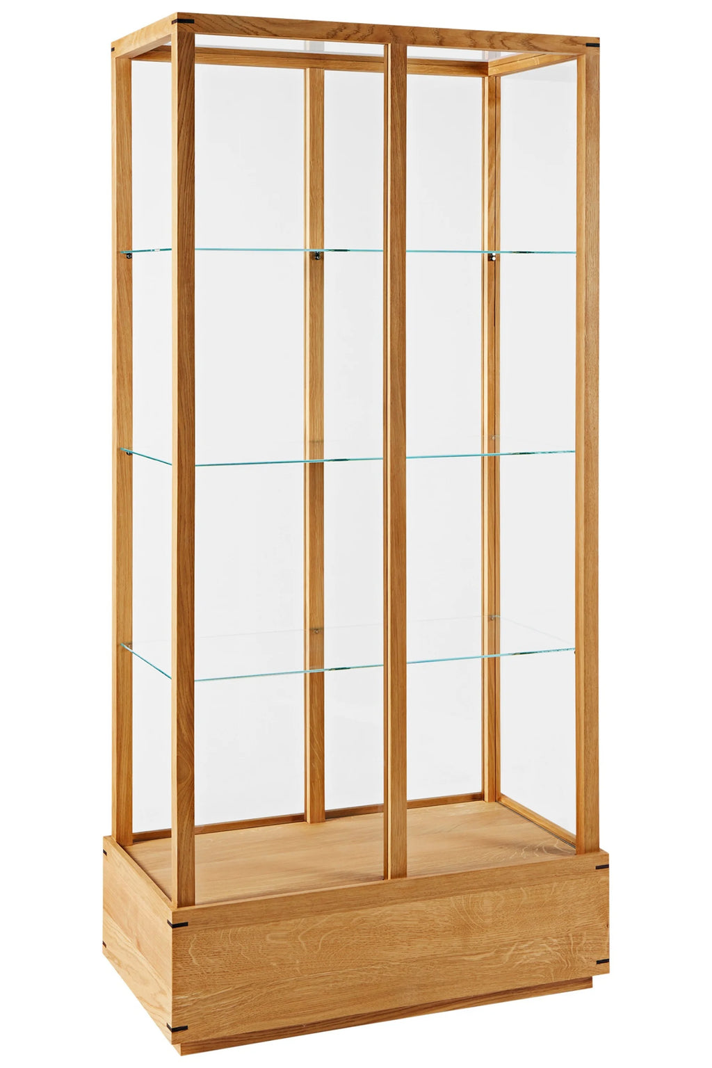 Kristina Dam Japanese Cabinet L, a tall modern minimalist display cabinet crafted from natural solid oak wood with clear glass panels and three adjustable glass shelves. This elegant Scandinavian-inspired showcase features exposed joinery details on its sturdy oak base, perfect for displaying collectibles or books in a contemporary living room, dining room, or home office.