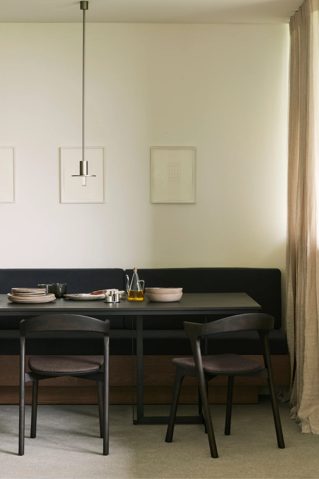 Ethnicraft Tacet Dining Table, a sleek modern minimalist dining table featuring a rectangular dark grey matte tabletop and a sturdy black metal frame with clean, contemporary lines. This sophisticated dining table is perfect for stylish dining rooms and modern kitchen spaces, offering a refined aesthetic.