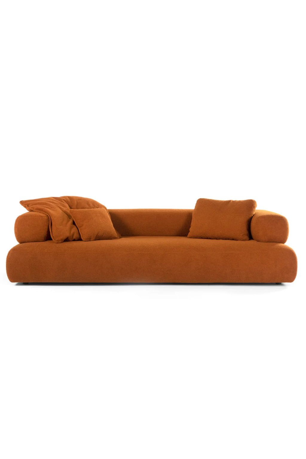 Hessentia Cholet Sofa, a contemporary burnt orange sofa upholstered in a plush, textured bouclé fabric with a distinctive low-profile and organic rounded silhouette. This inviting 3-seater features soft, deep seating, curved arms, and includes matching accent pillows for ultimate comfort. Ideal for modern minimalist living rooms or cozy organic modern interiors.