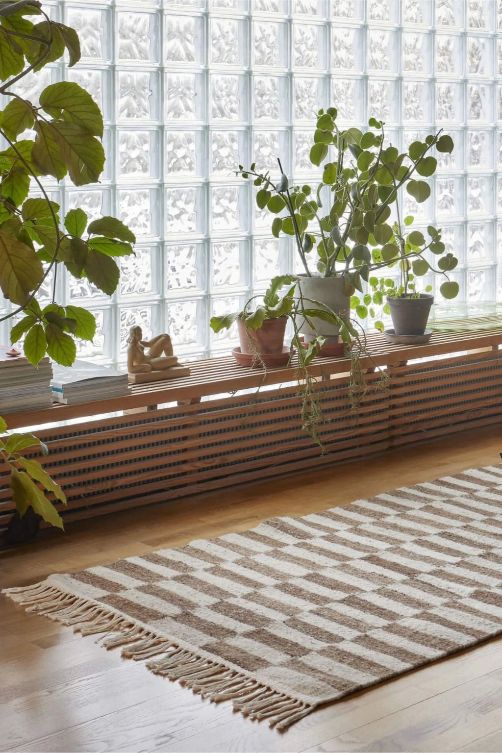 Sera Helsinki Abeba Rug, a hand-woven wool area rug featuring a modern geometric pattern of natural cream and warm brown rectangular blocks with a plush textured finish and fringed edges. This Scandinavian-inspired design is perfect for adding organic warmth to minimalist living rooms, Japandi bedrooms, or cozy entryways.