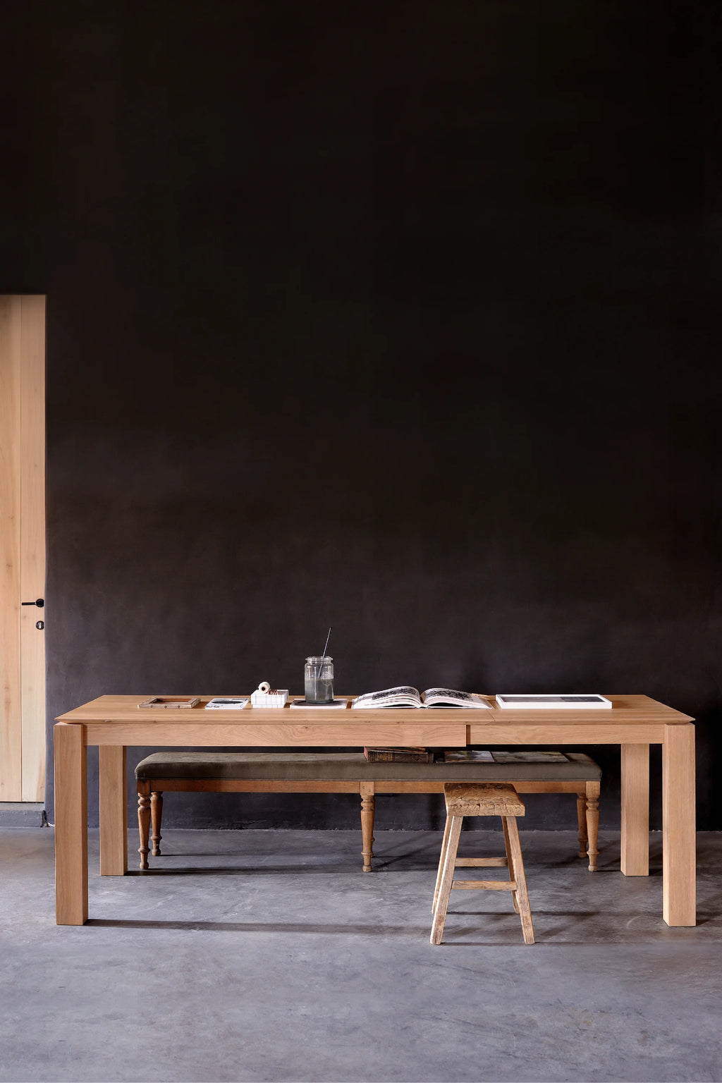 Ethnicraft Slice Extendable Dining Table, a large modern minimalist dining table crafted from solid natural oak wood, featuring a clean rectangular tabletop and thick, sturdy square legs. This contemporary oak table showcases beautiful natural wood grain, light tones, and a sleek, understated design, making it a versatile extendable dining table for spacious dining rooms or modern kitchens.