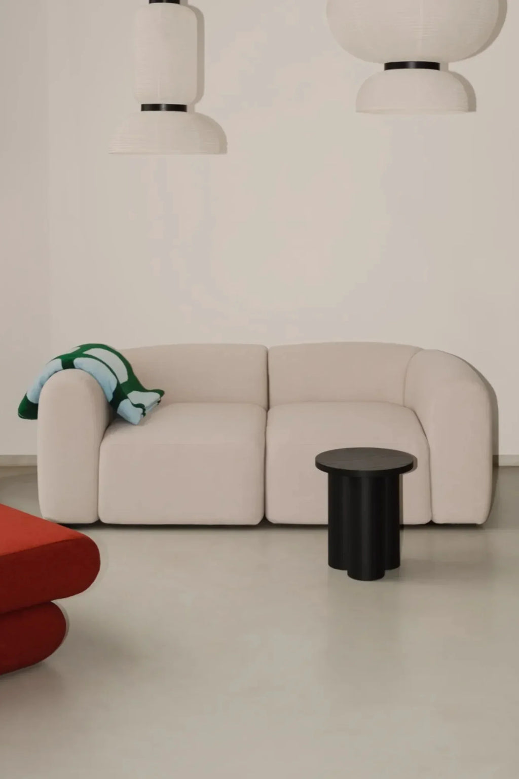noo.ma Flom 2-Seater Sofa, a compact organic modern sofa upholstered in a light cream textured fabric, featuring soft, rounded edges and a plush, low-profile design. This contemporary 2-seater sofa offers comfortable seating with minimalist Scandinavian lines, ideal for small apartment living rooms or cozy minimalist spaces.