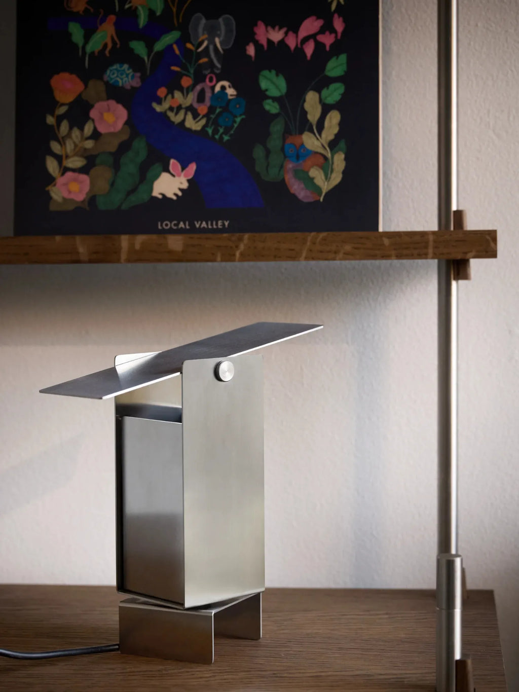 MOEBE Pivoting Table Lamp, a sleek modern minimalist desk lamp crafted from brushed silver metal with a geometric rectangular body and an adjustable, pivoting flat head. Its industrial chic design and contemporary Scandinavian aesthetic make it perfect for a home office, bedside table, or as stylish accent lighting for modern interiors.