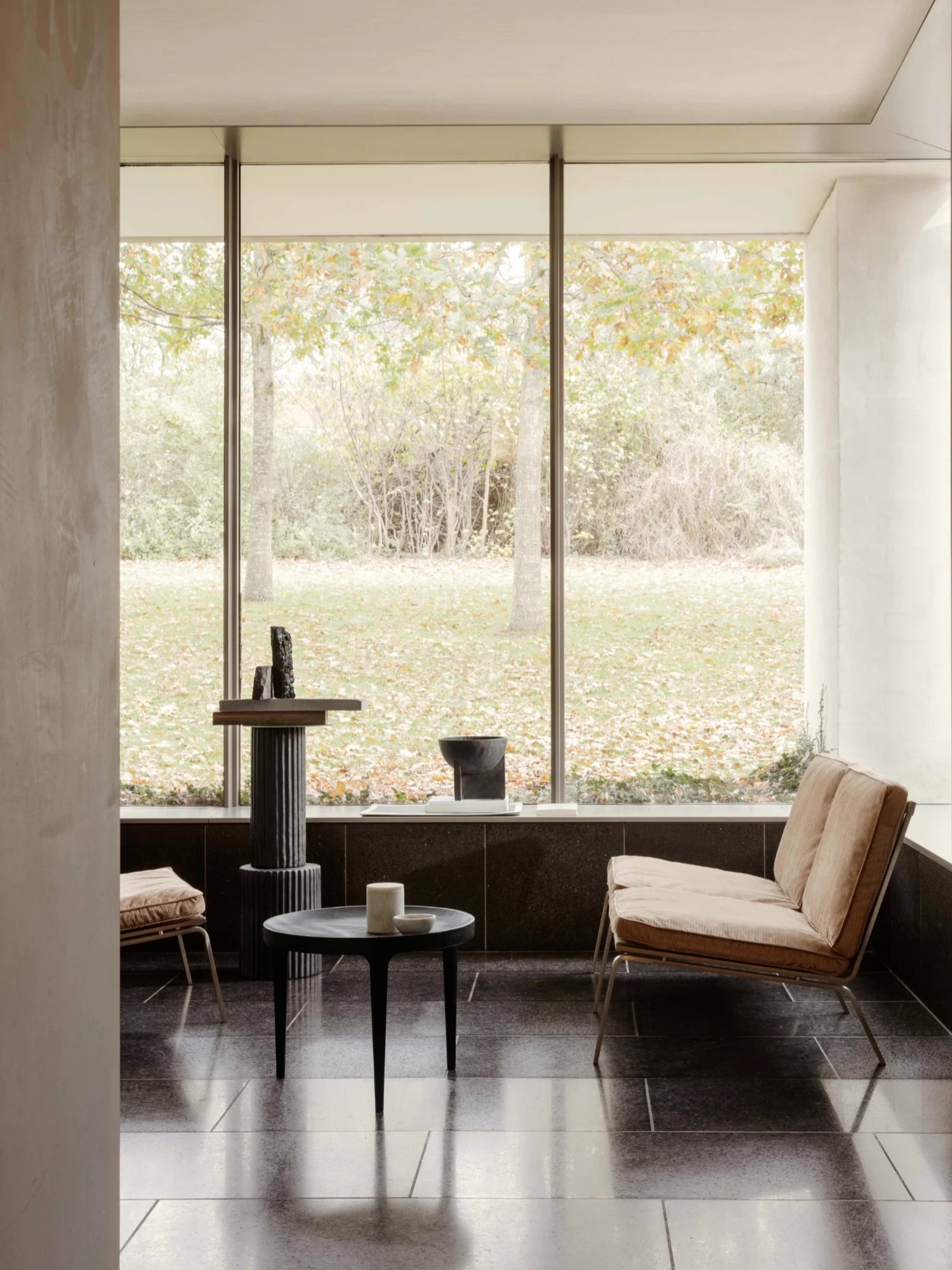 NORR11 Man 2 Seater Sofa, a modern minimalist lounge chair featuring plush tan corduroy cushions and a sleek, exposed silver metal frame with a low-profile design. This contemporary 2-seater sofa offers comfortable seating for a living room, reading nook, or stylish office lounge area.