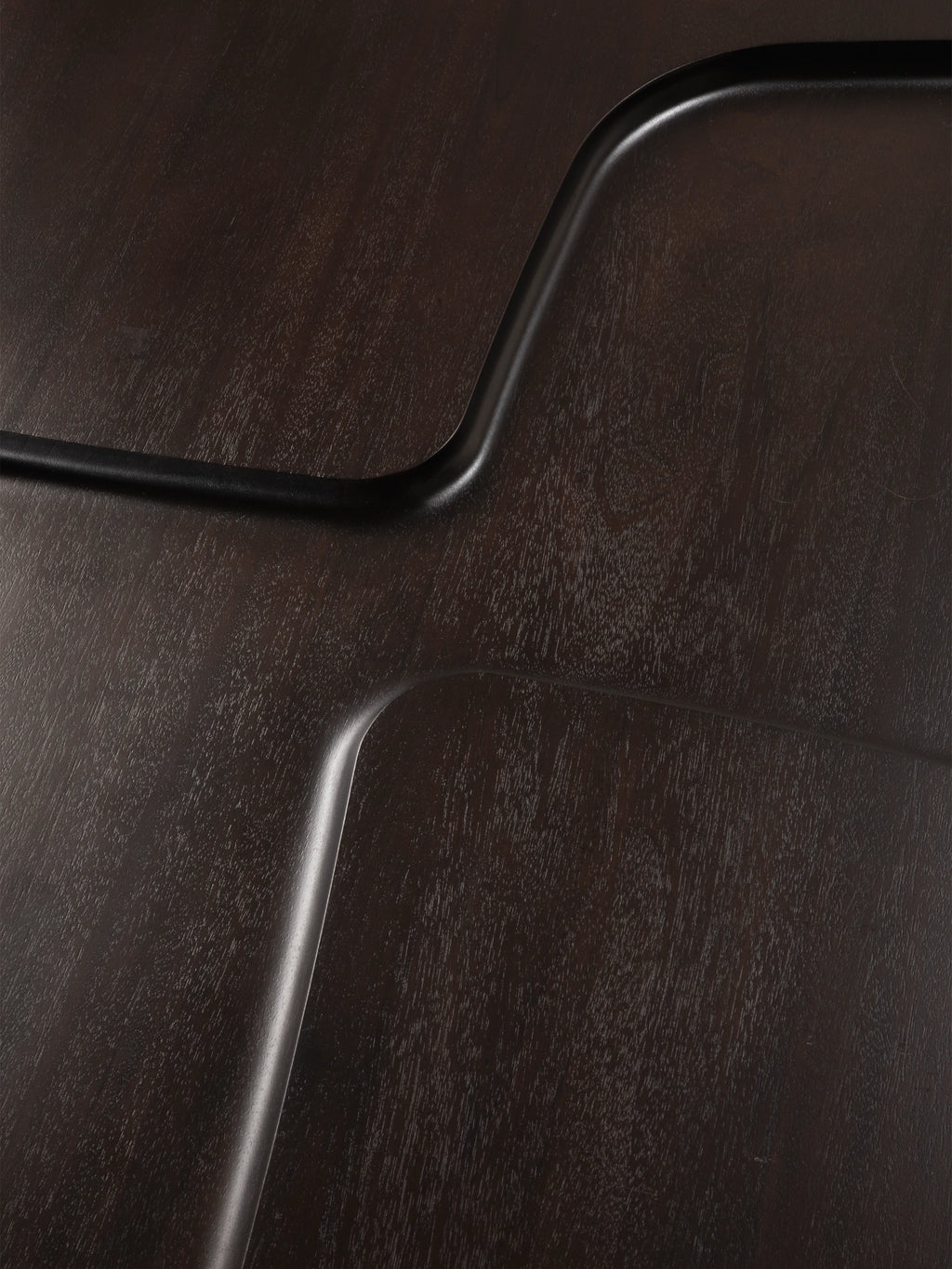 Ethnicraft Brutalist Side Table, a dark stained solid wood side table with a deep brown, almost black finish, showcasing prominent wood grain texture and bold, matte black sculptural lines that flow across its surface.